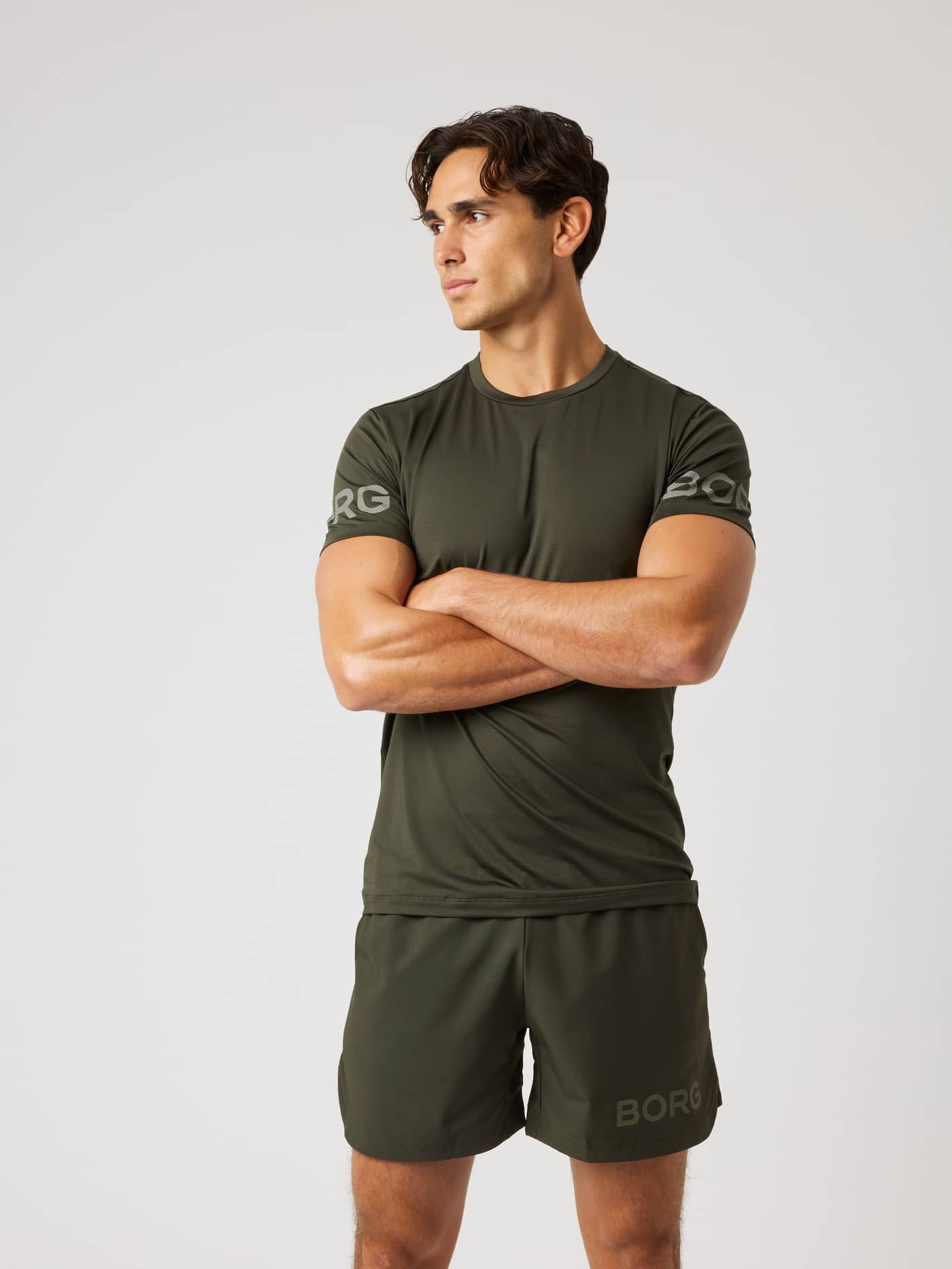Front view of a man wearing the Borg T-Shirt in Rosin (Green), a training top with light grey logos on the sleeves. - Image 2