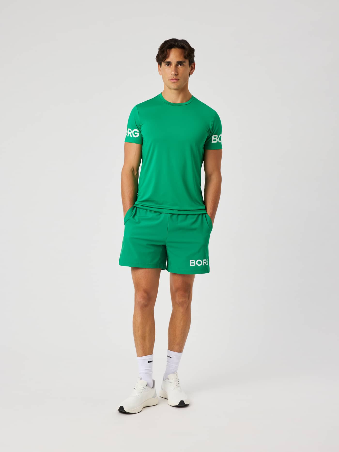 Model wearing the Borg T-Shirt in Jolly Green (green) featuring a white Borg logo on the arms for training. - Image 4