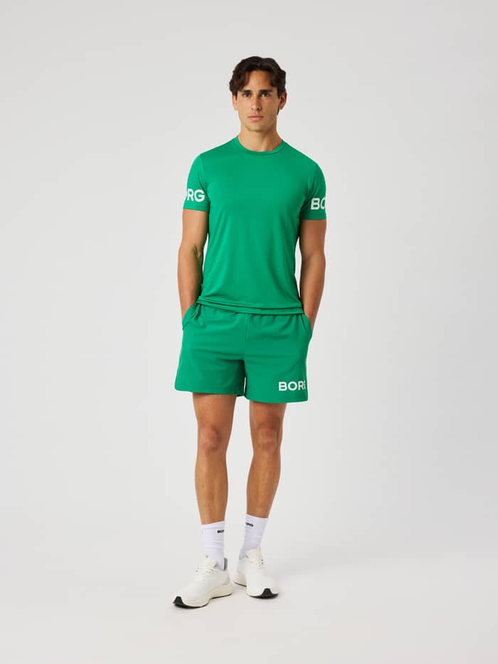 Model wearing the Borg T-Shirt in Jolly Green (green) featuring a white Borg logo on the arms for training.