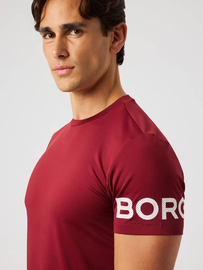 Close-up of the Borg T-Shirt in Cabernet (red) highlighting the white Borg logo on the arm for training.