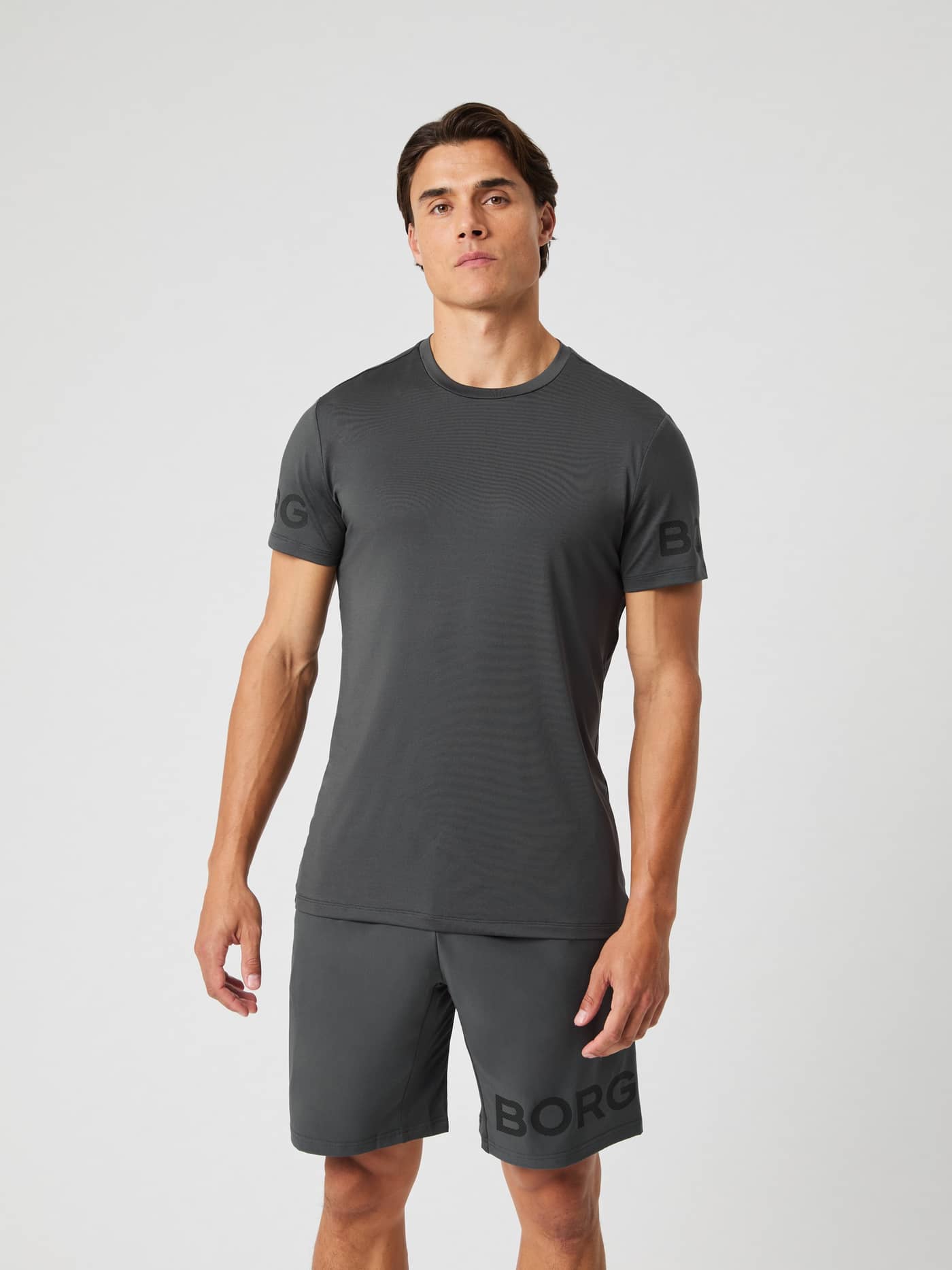 Male model wearing the Borg T-shirt in asphalt grey with matching shorts, shown from the front. - Image 4