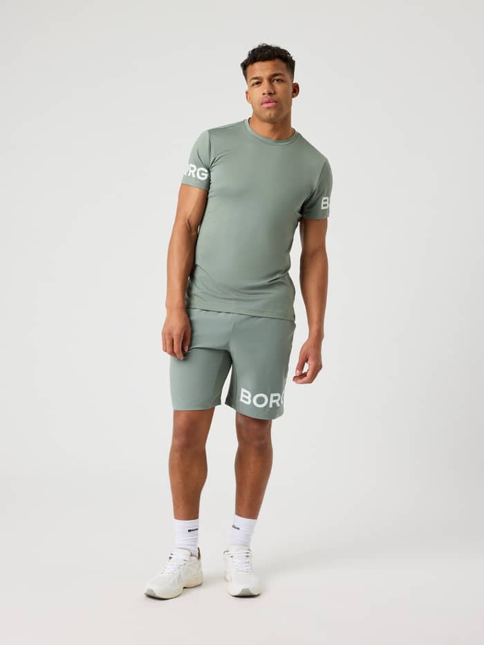 Front view of a male model wearing the Agave Green Borg T-shirt and matching shorts.