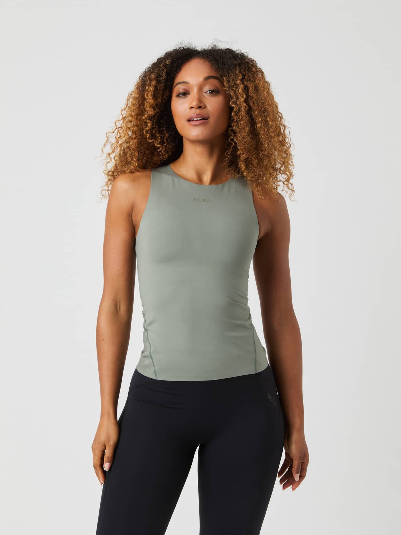 Front view of a model wearing the slim-fit Björn Borg Studio 2 In 1 Tank Top in Agave Green (Green) for training. - Image 1