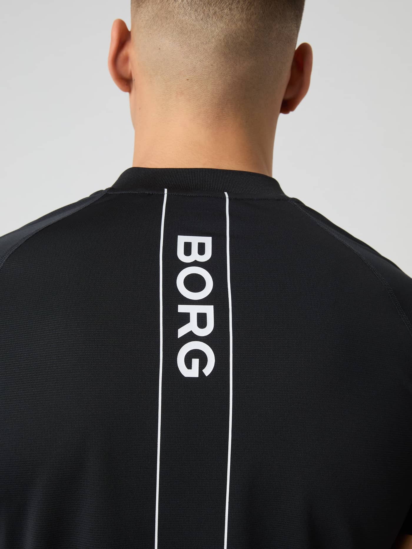 Back view of the recycled Björn Borg Ace Zip Polo Shirt in Black Beauty (Black) with a white logo for tennis performance. - Image 5