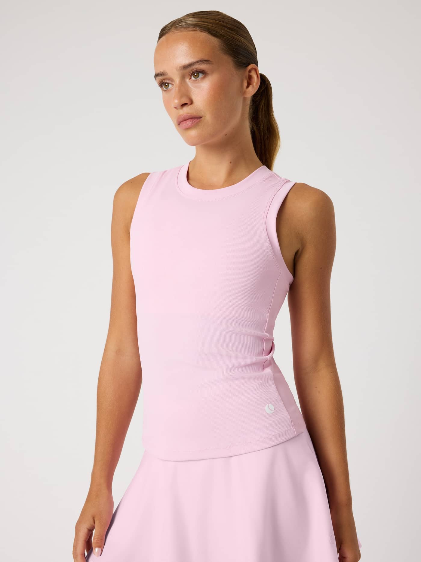 Front view of the Björn Borg Ace Pocket Ribbed Tank Top in Pink Lady (Pink), a slim fit tennis top with a white logo. - Image 6