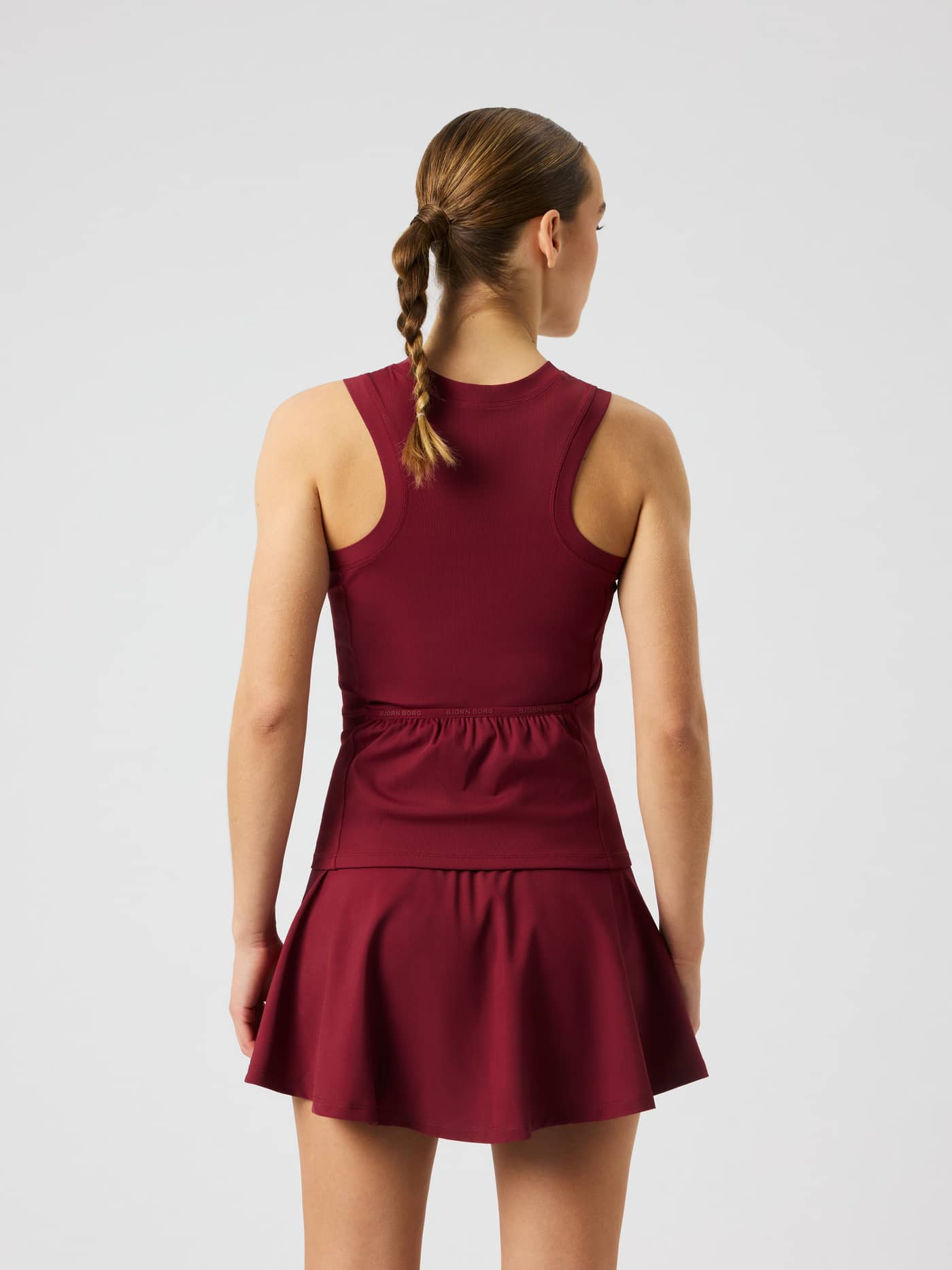 Back view of the Ace Pocket Ribbed Tank Top in Cabernet (Red) highlighting the racerback design and tennis pocket. - Image 2