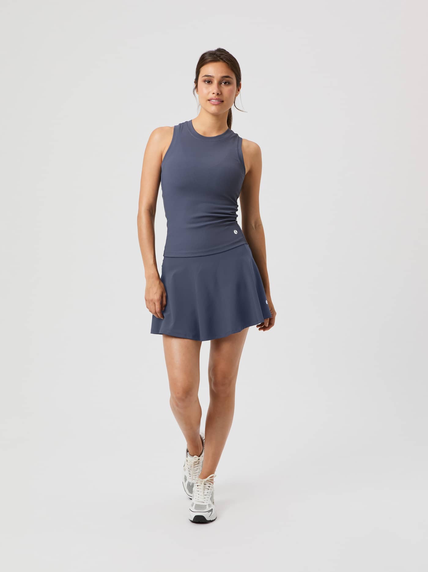 Full-length front view of a woman wearing the Björn Borg Ace Pocket Ribbed Tank Top in Odyssey Gray. - Image 3