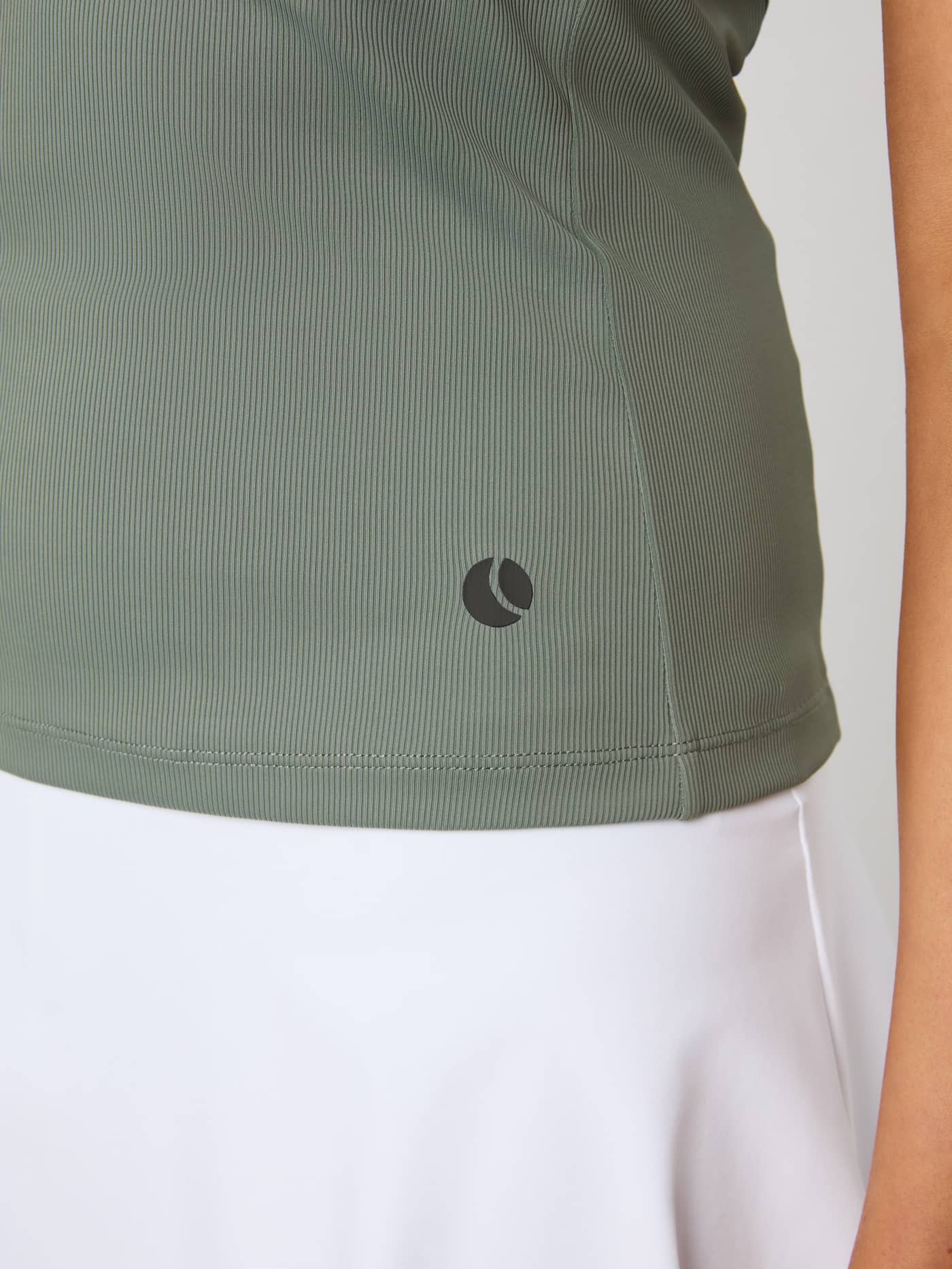 Close-up of the Ace Pocket Ribbed Tank Top in Agave Green, showing the ribbed texture and tennis ball logo on the hip. - Image 5