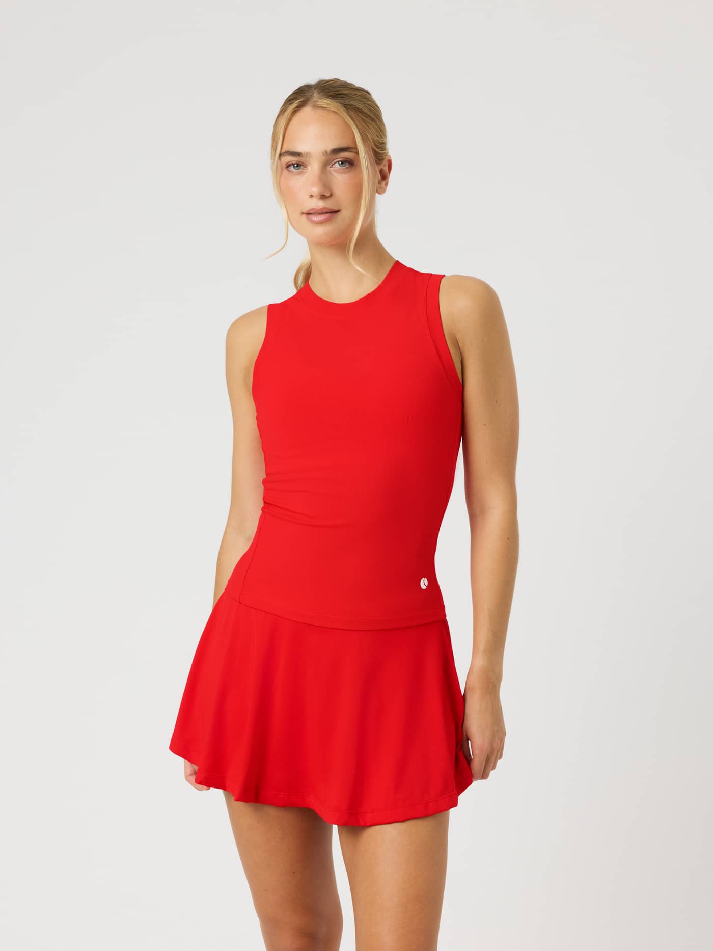 Front view of a model wearing the Ace Pocket Ribbed Tank Top in Flame Scarlet (Red) for a slim-fit tennis style. - Image 2