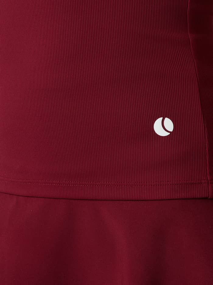 Close-up of the Ace Pocket Ribbed Tank Top in Cabernet (Red) highlighting the white tennis ball logo on the hip.