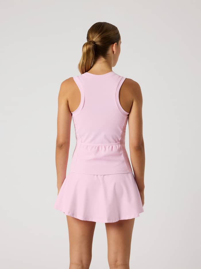 Back view of a model in the slim-fit Björn Borg Ace Pocket Ribbed Tank Top in Pink Lady (Pink) with a racerback for tennis.