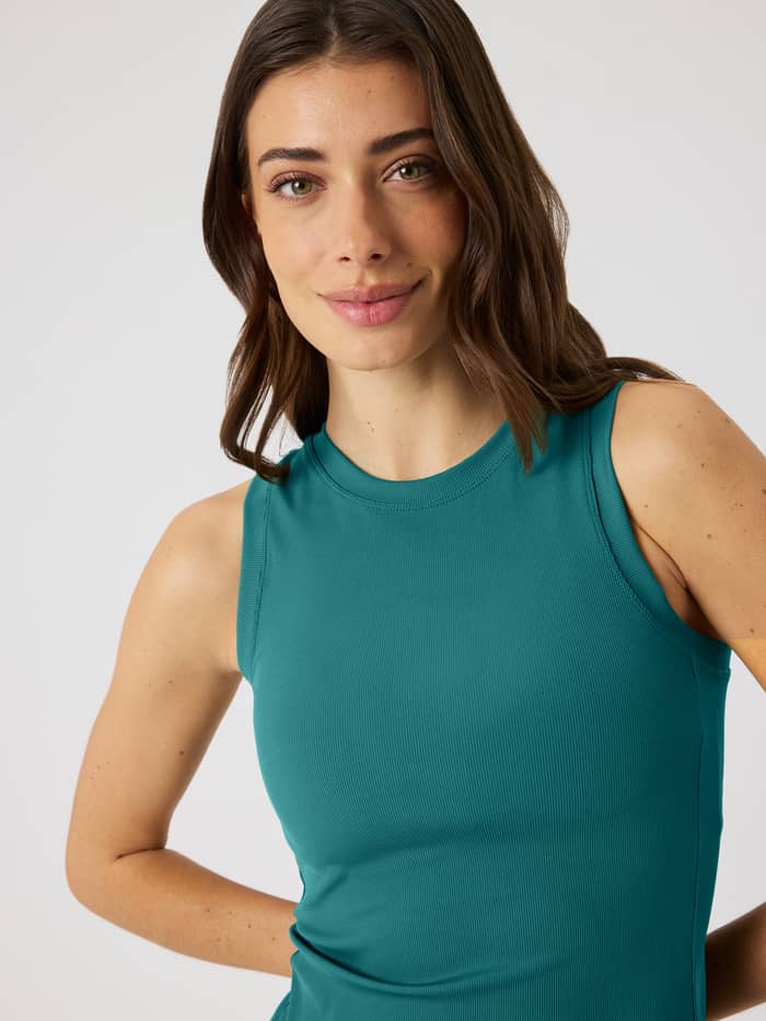 Front view of a model wearing the Ace Pocket Ribbed Tank Top in Mallard Green (Green) for a slim-fit tennis style.