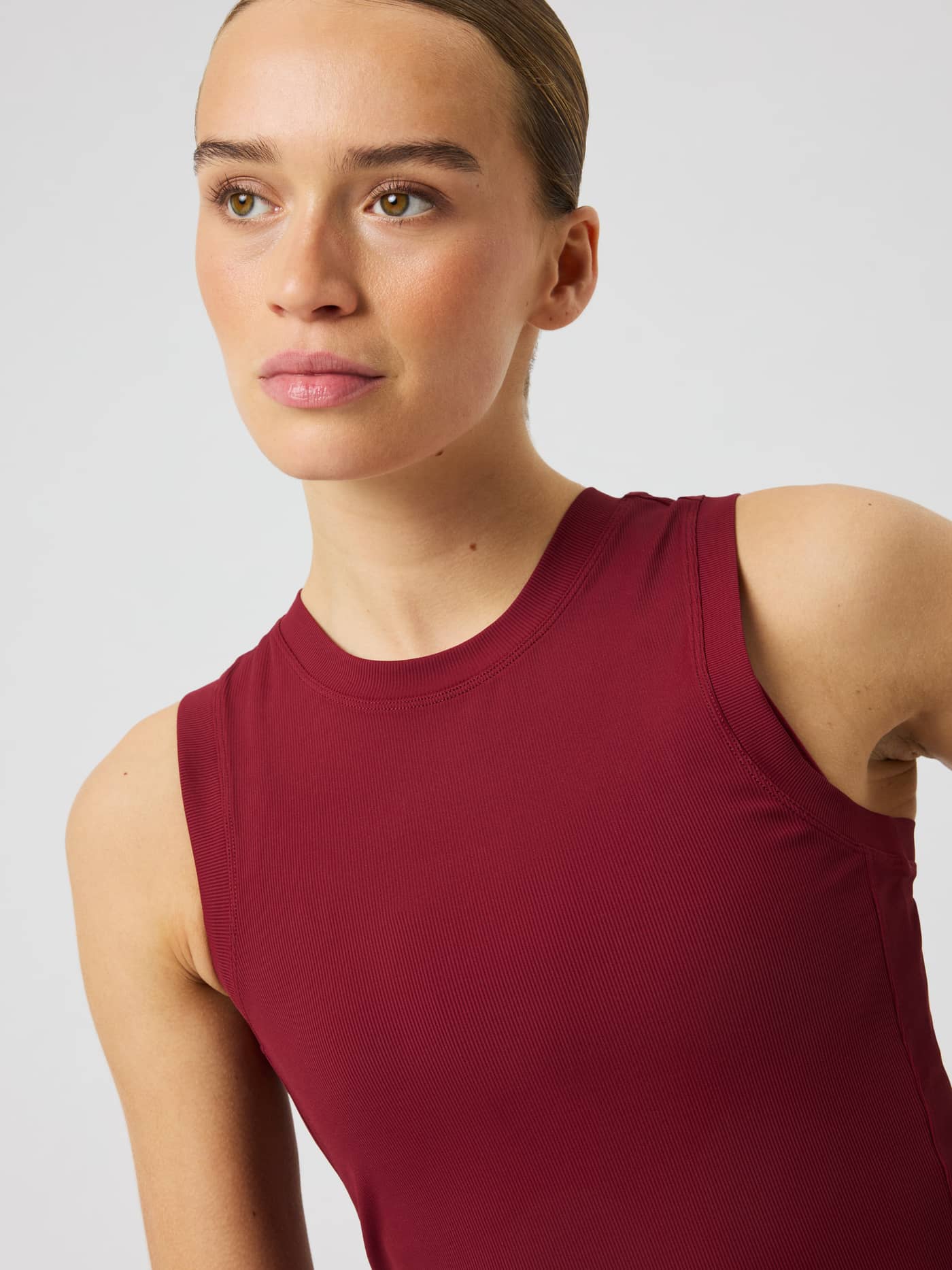Close-up of the Ace Pocket Ribbed Tank Top in Cabernet (Red) highlighting the round neck and soft rib fabric. - Image 6