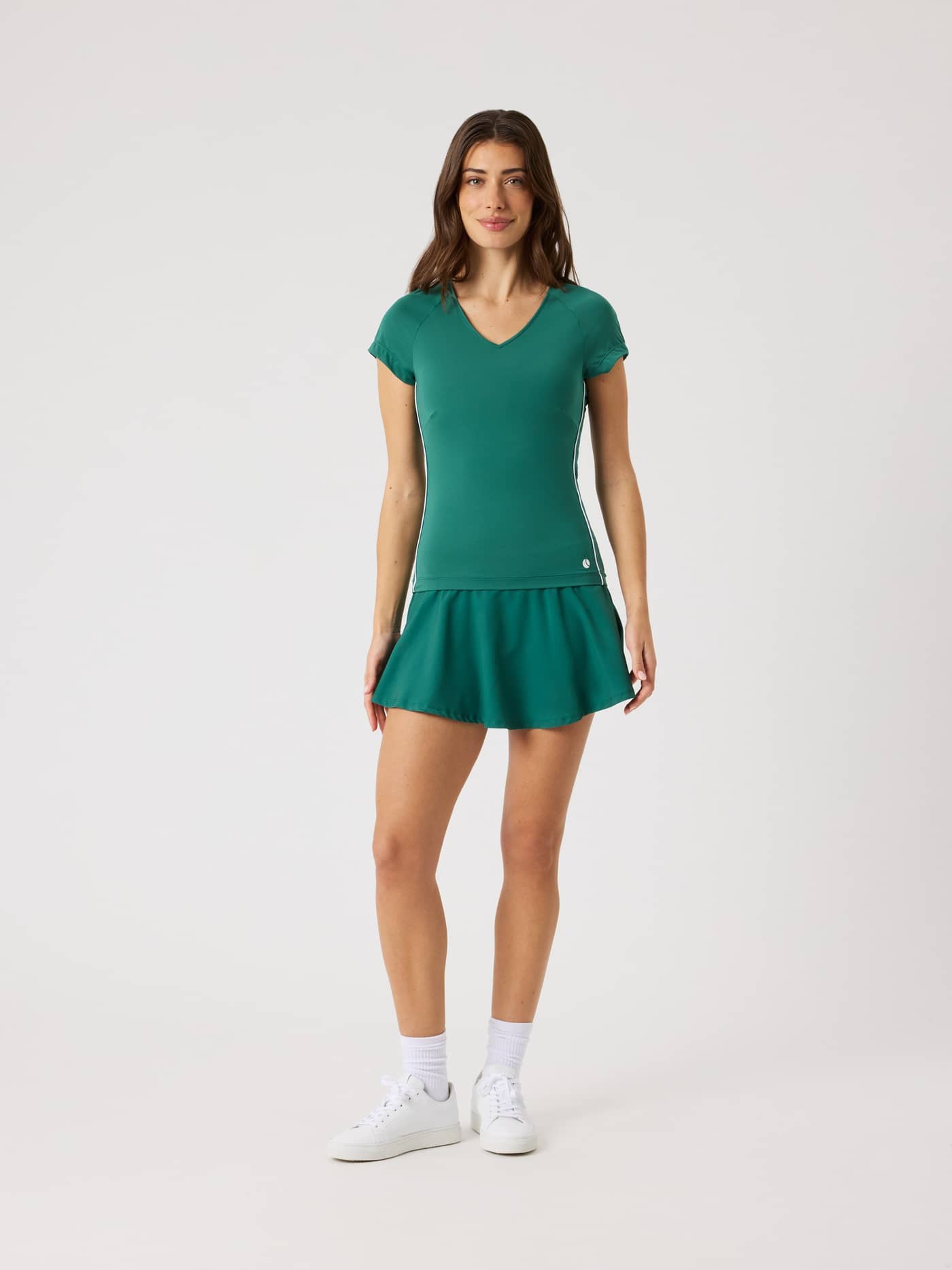 Full-body front view of a woman wearing the slim-fit Ace V-Neck T-Shirt in Posy Green (Green) for tennis. - Image 3