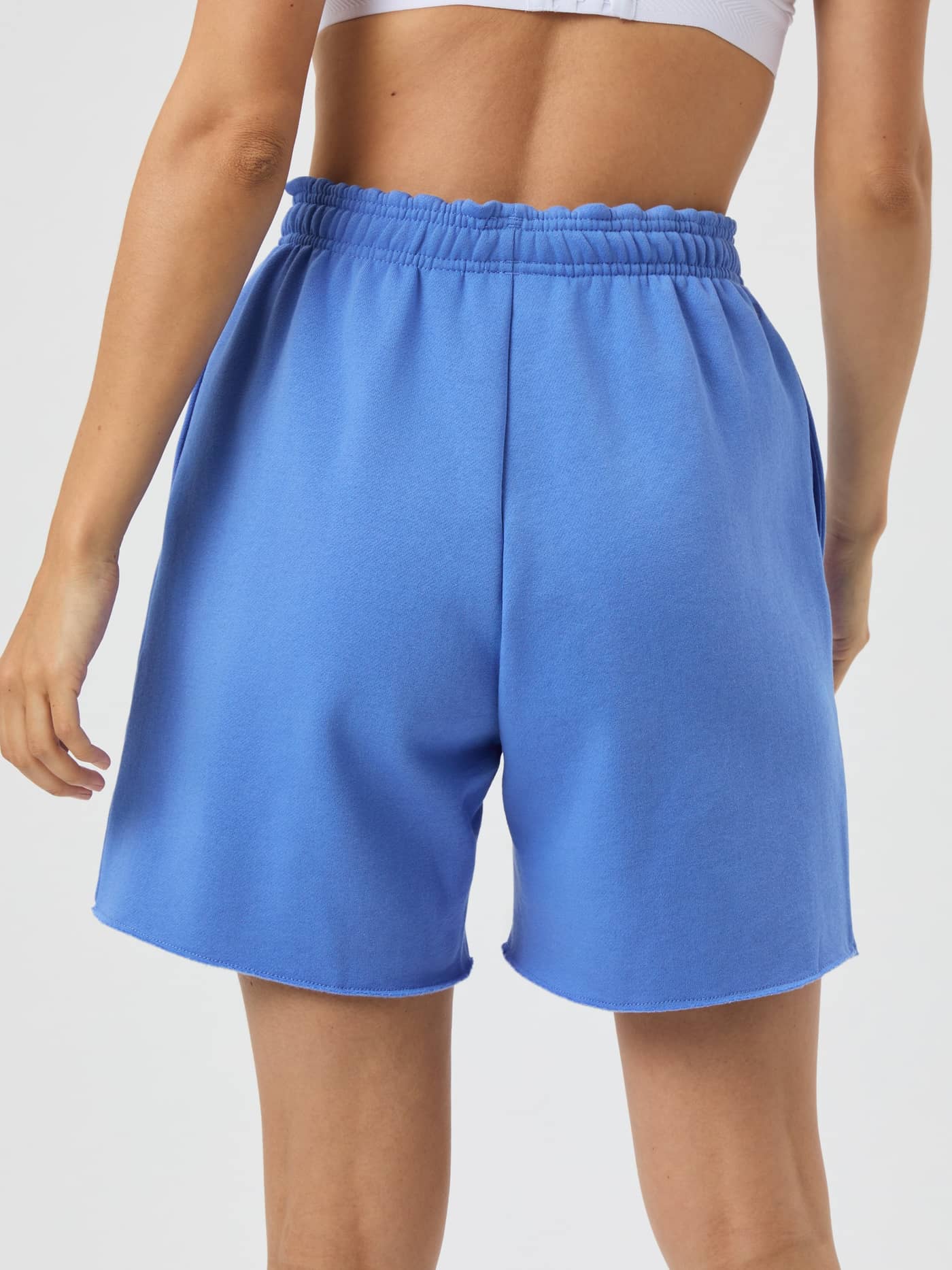 Back view of a woman in the Björn Borg Studio Oversized Sweatshorts in Ultramarine (Blue), with a comfortable relaxed fit. - Image 3