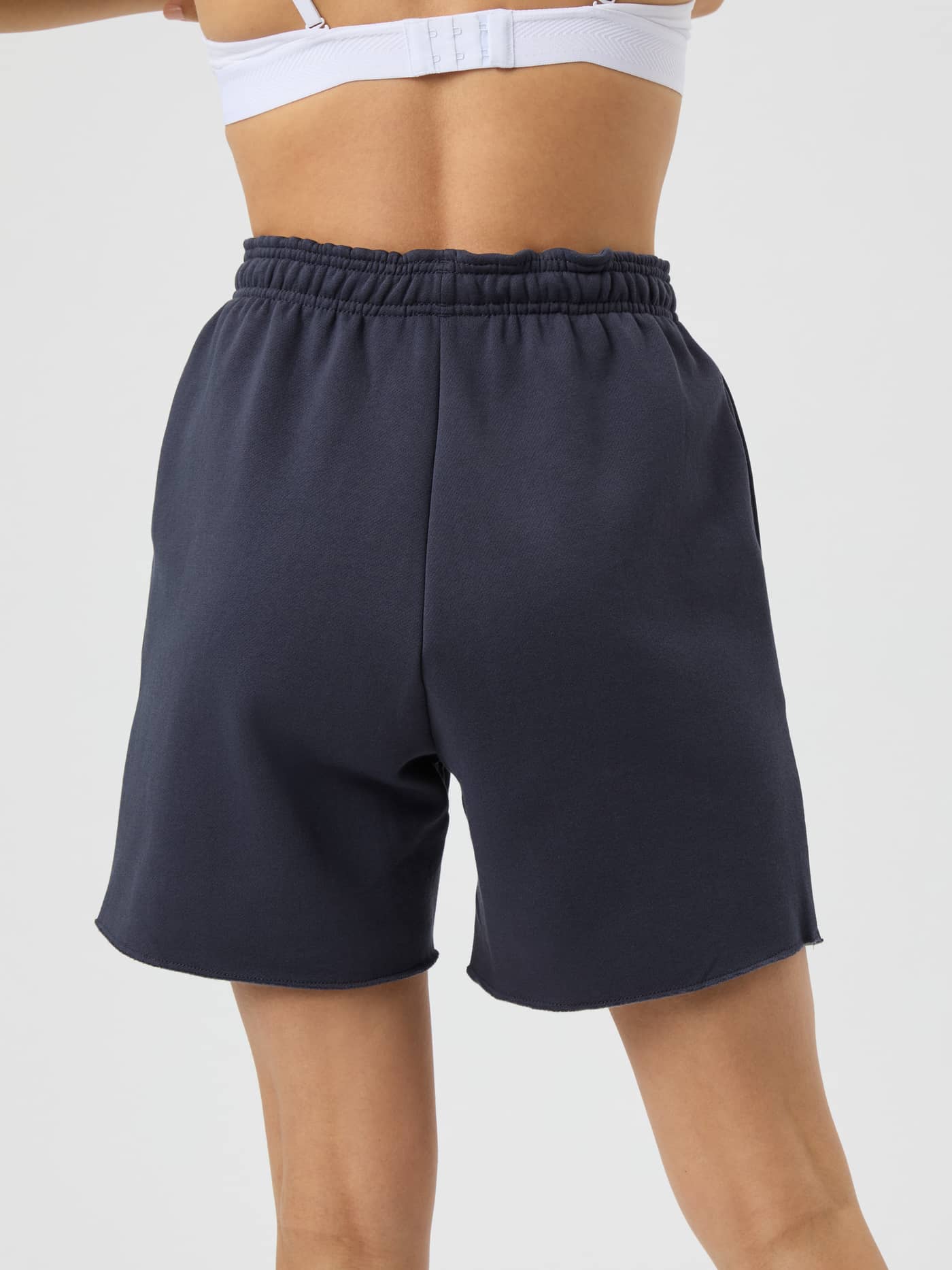 Studio Oversized Sweatshorts i Odyssey Gray (Grå) sett bakfra på en kvinne til studiotrening. - Image 3
