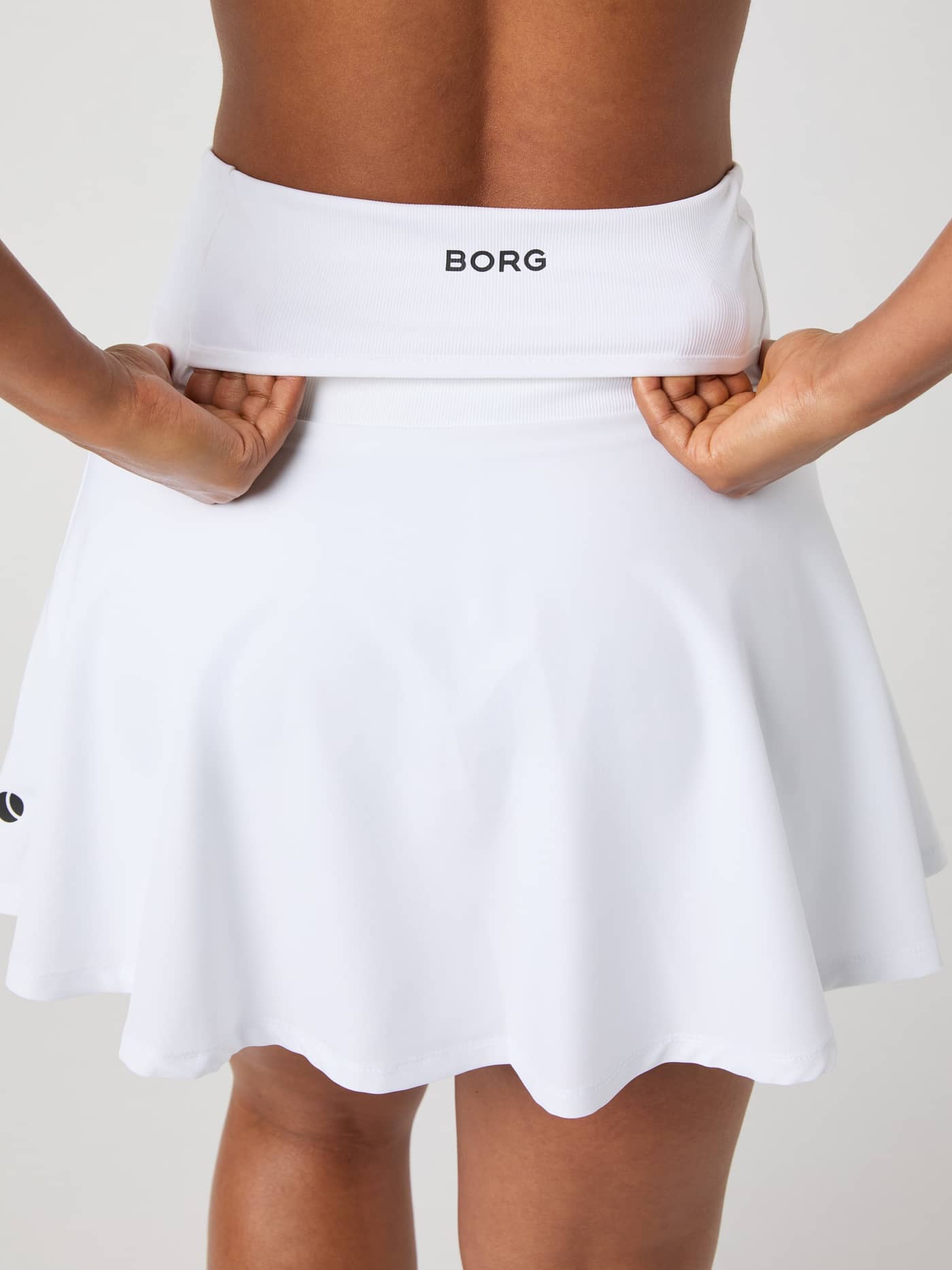 Close-up of the back pocket detail on the waistband of the white Björn Borg Ace Skirt Pocket. - Image 5