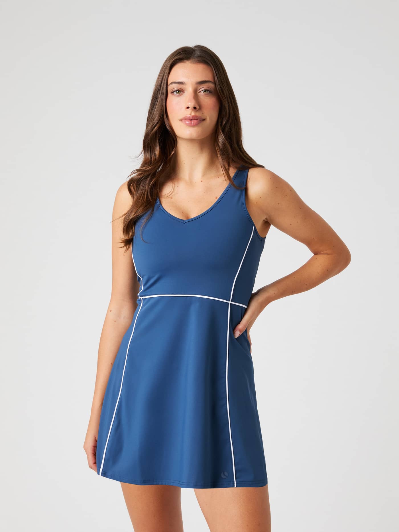 Front view of a woman in the Björn Borg Ace V Dress in Sargasso Sea (Blue) for tennis with white outlines and logo. - Image 2