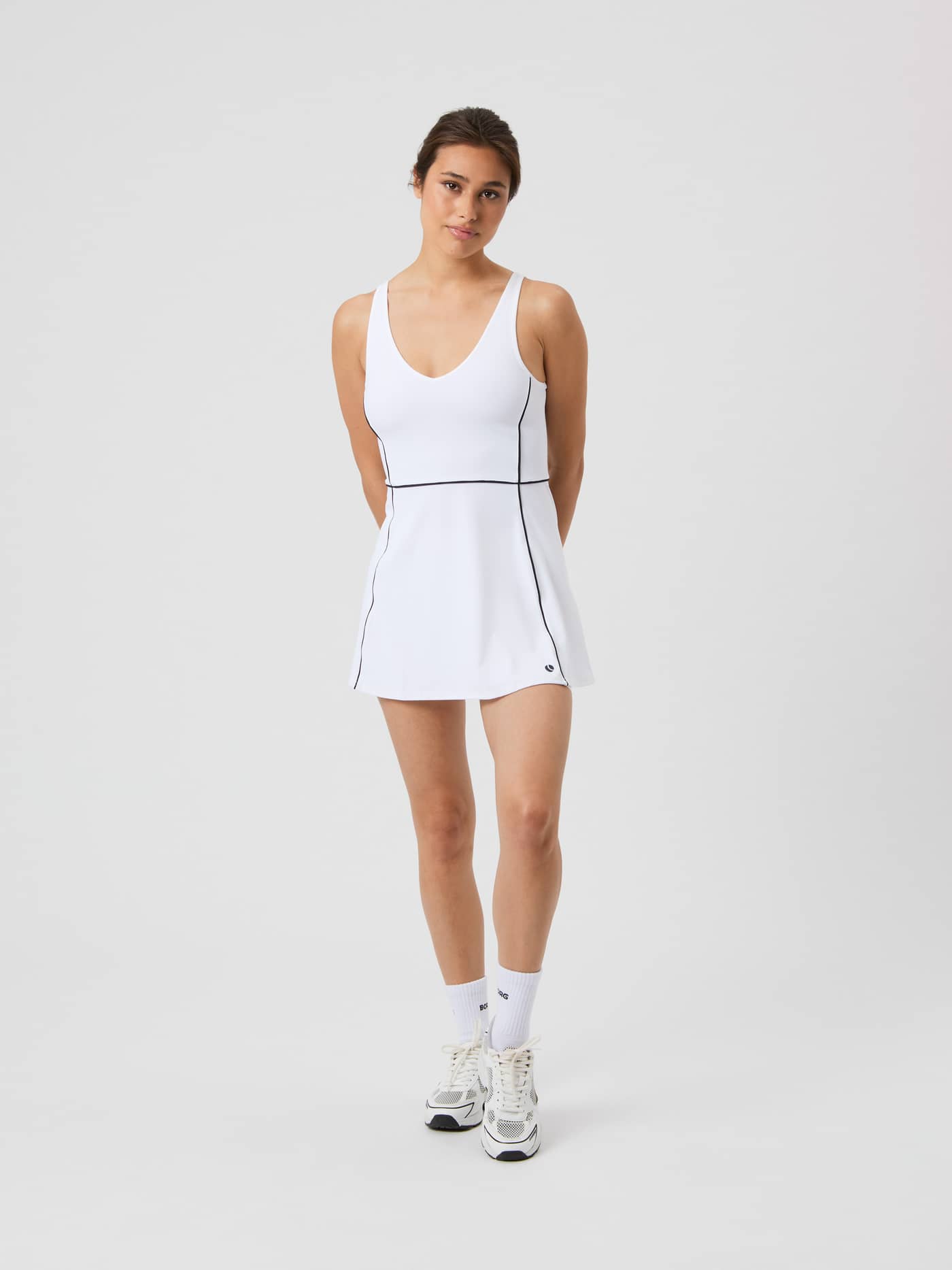 Full-body front view of the Björn Borg Ace V Dress in Brilliant White (White), a stylish tennis dress with a black logo. - Image 3