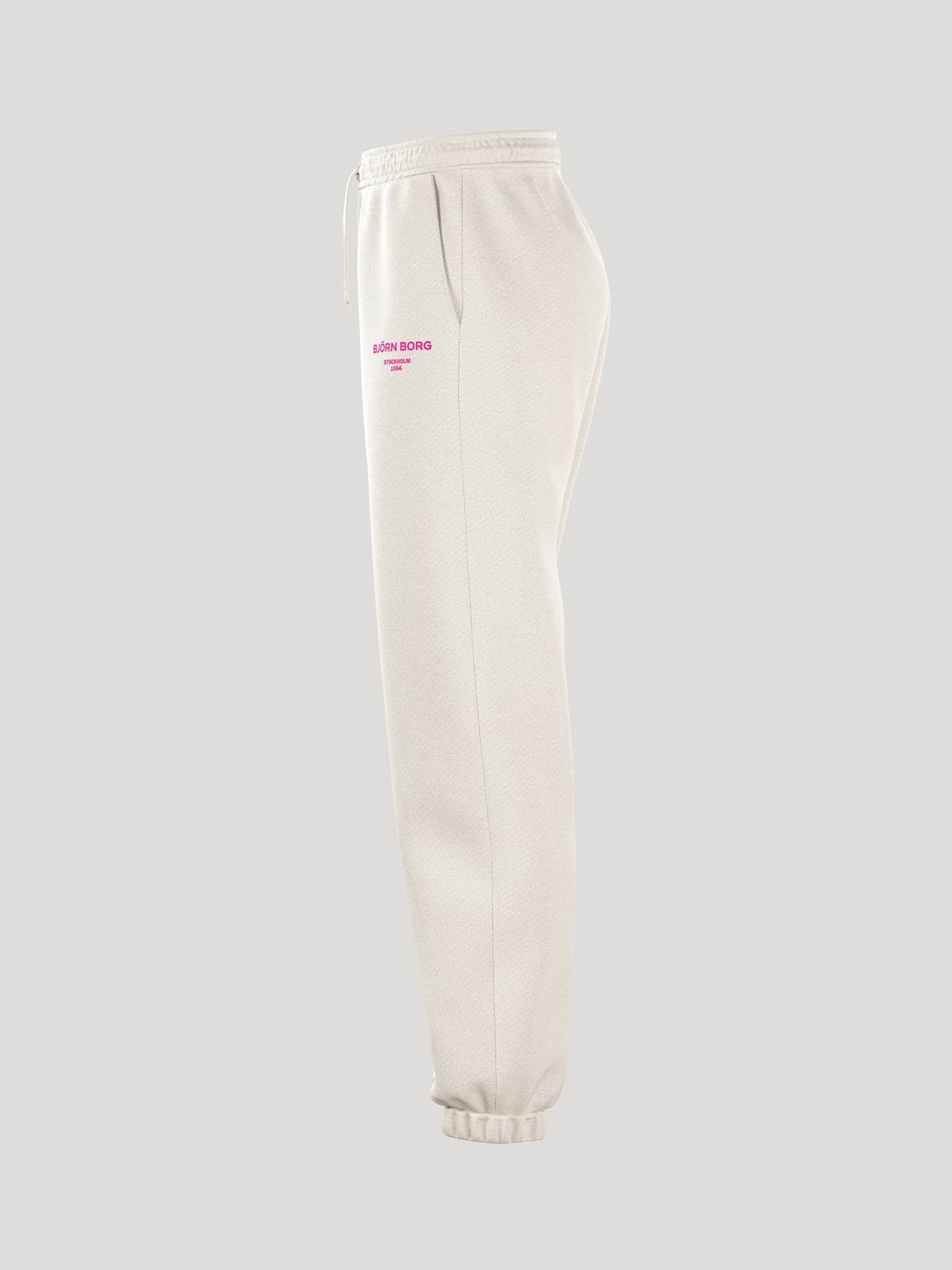 Side profile studio shot of the women's Borg Essential 1 Sweatpants in an off-white Tofu colour. - Image 4