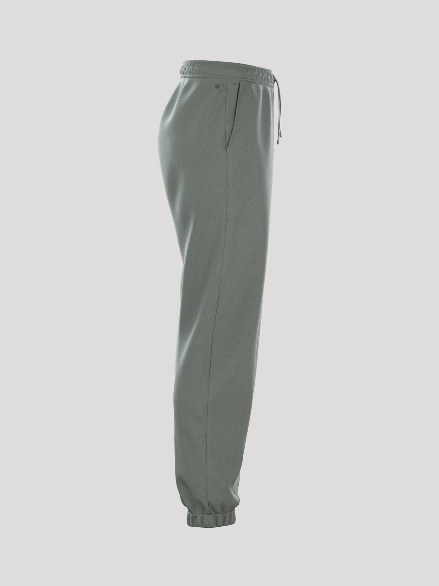 Side view of the women's Borg Essential 1 Sweatpants in Agave Green (Green) featuring a loose fit and ribbed cuffs. - Image 2