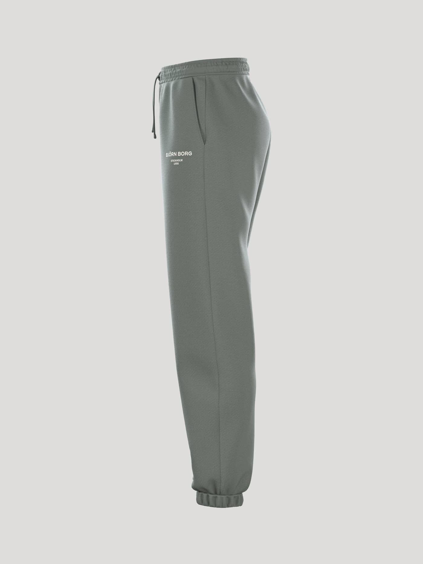 Side view of the women's Borg Essential 1 Sweatpants in Agave Green (Green) with a stylish loose fit and ribbed cuffs. - Image 4