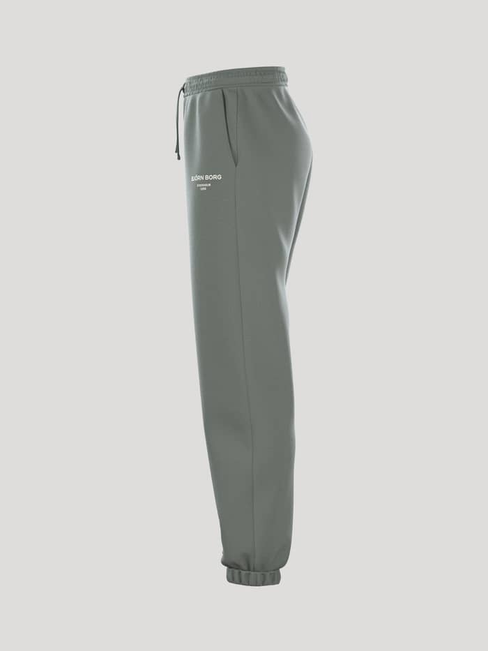 Borg Essential 1 Sweatpants i Agave Green (Grøn) set fra siden med en stilfuld løs pasform og ribbede manchetter. - Image 4
