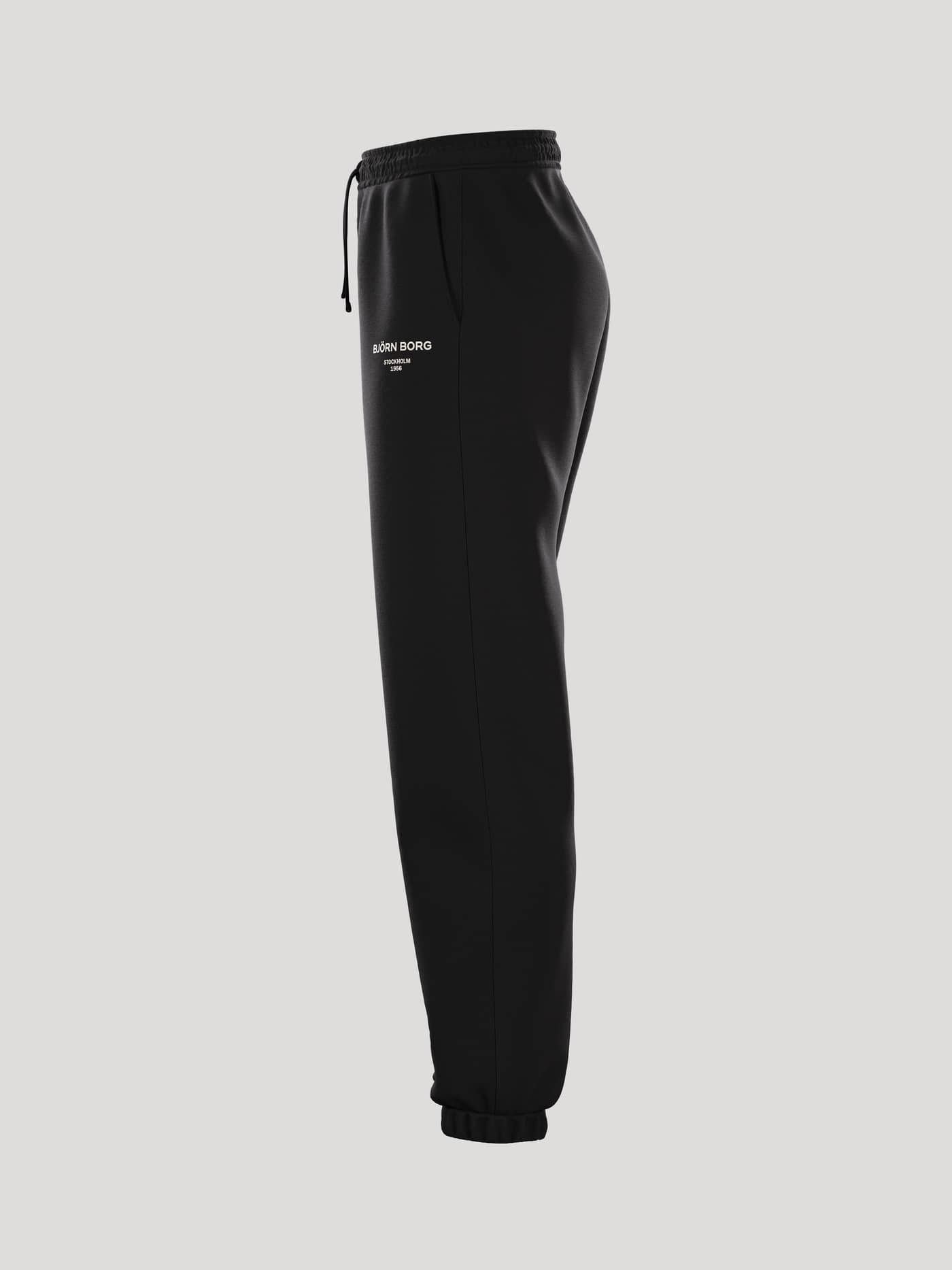 Zijaanzicht van de Borg Essential 1 Sweatpants voor dames in Black Beauty (Zwart) met wit logo en losse pasvorm. - Image 4