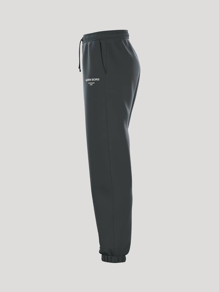 Zijaanzicht van de Borg Essential 1 Sweatpants voor dames in Urban Chic (Groen) met een losse pasvorm en een wit logo. - Image 4