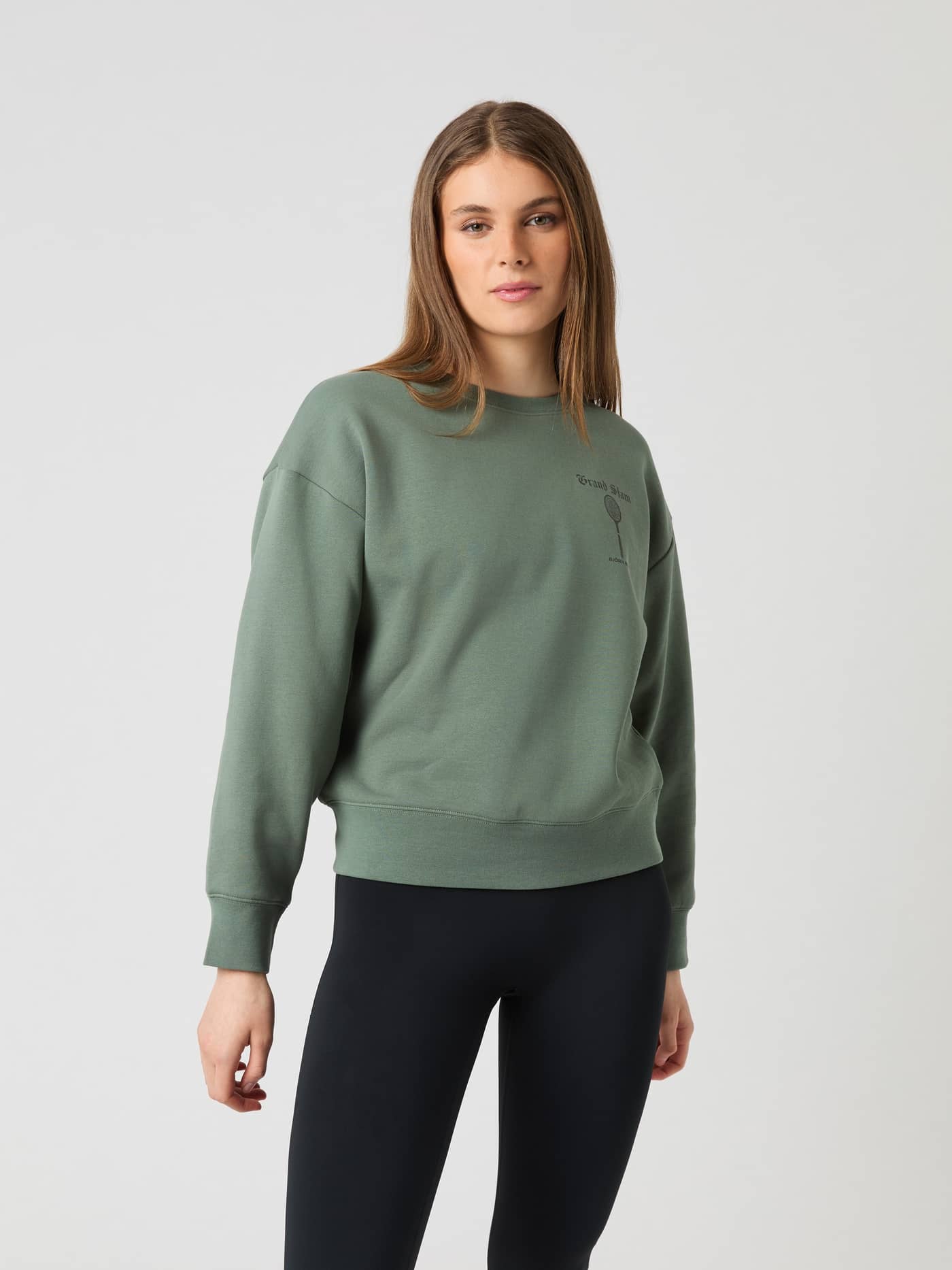 Front view of a model wearing the oversized Borg Boyfriend Sweatshirt in Agave Green (Green) with a tennis graphic. - Image 3
