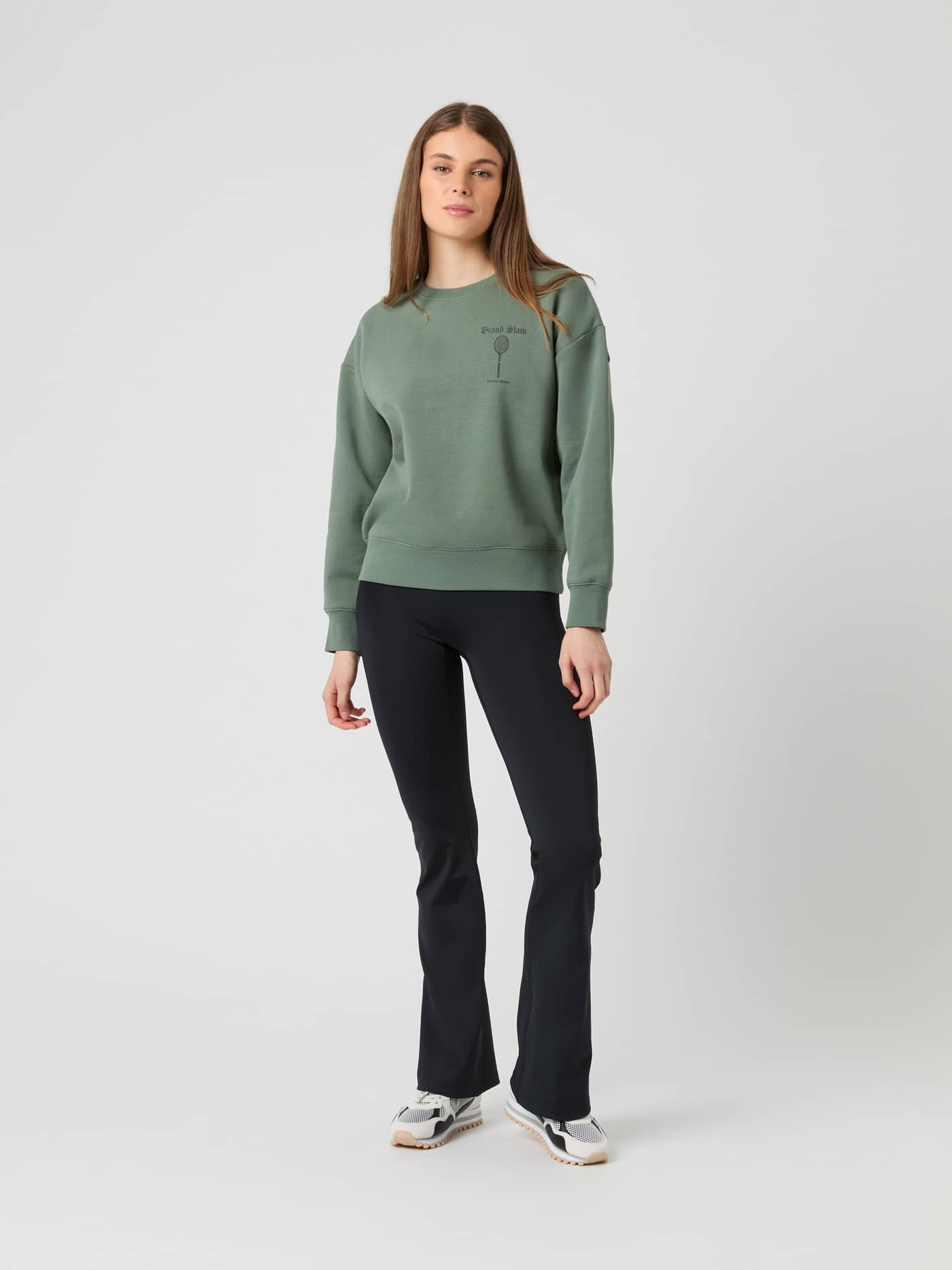 Full-body front view of a model wearing the oversized Agave Green (Green) Borg Boyfriend Sweatshirt with a tennis graphic. - Image 2
