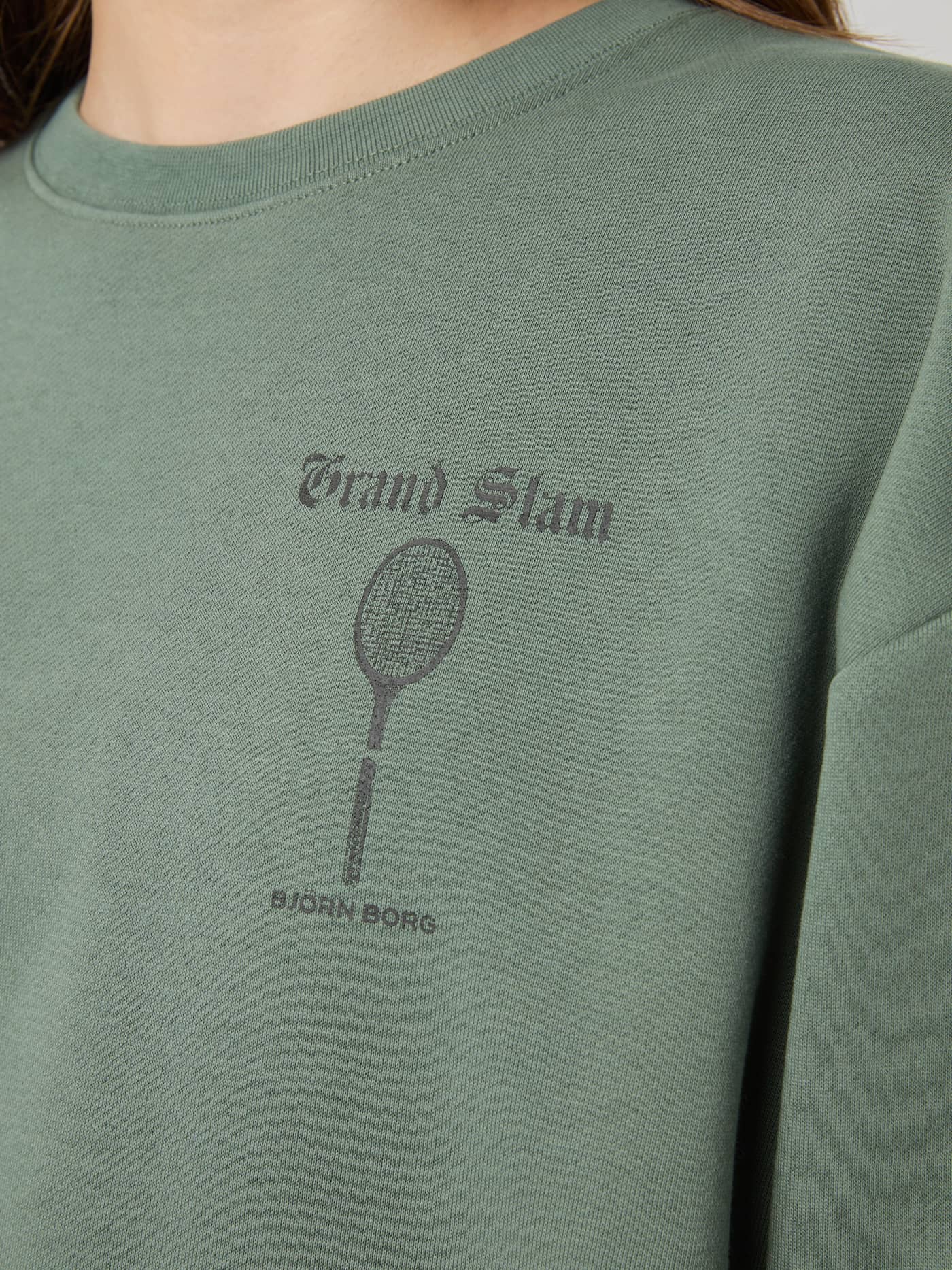 Close-up of the women's Agave Green (Green) Borg Boyfriend Sweatshirt in soft fleece with a black tennis chest graphic. - Image 4