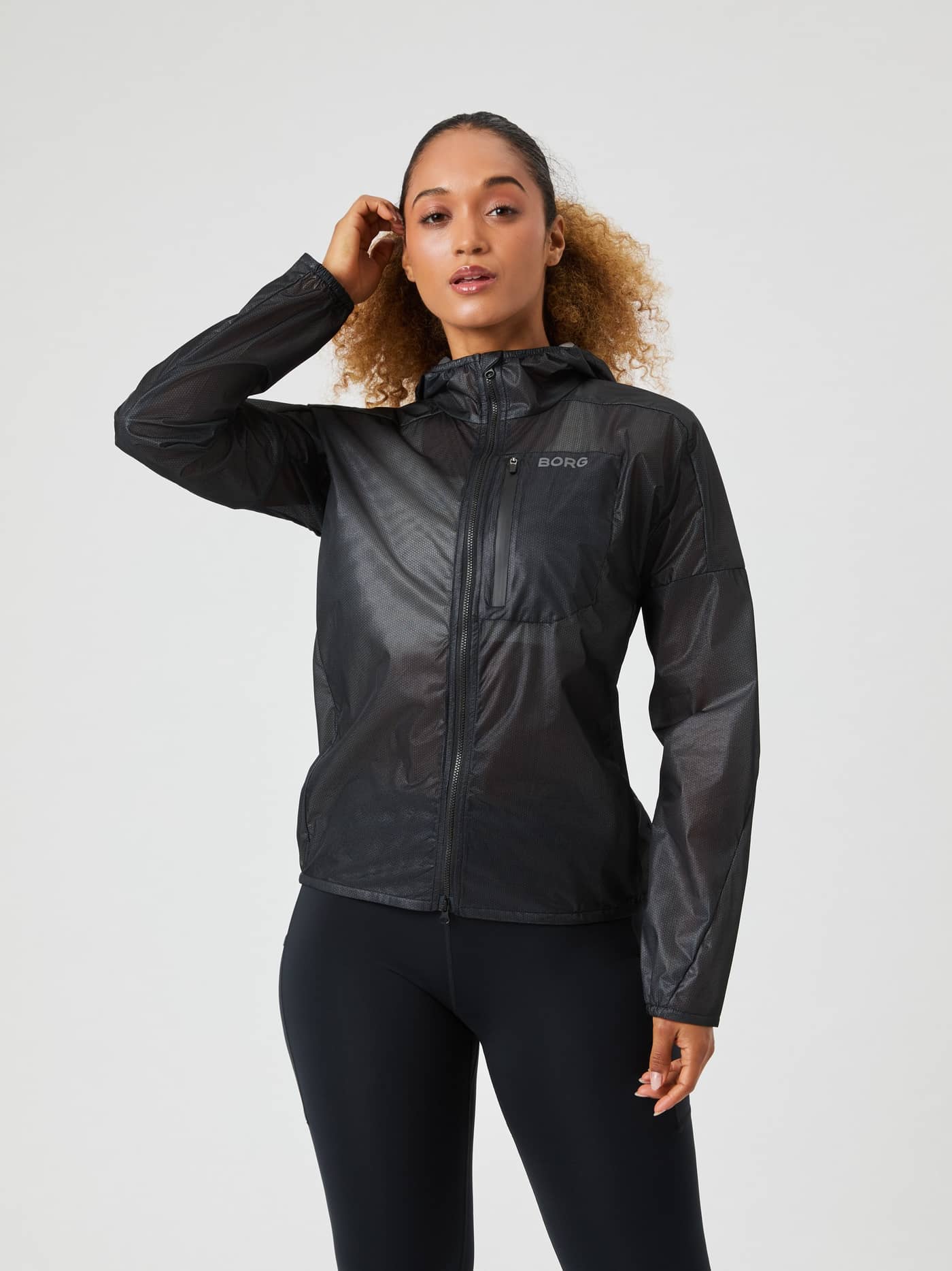 Front view of a woman wearing the Borg Running Jacket in Black Beauty (Black), a lightweight style with a performance fit. - Image 1