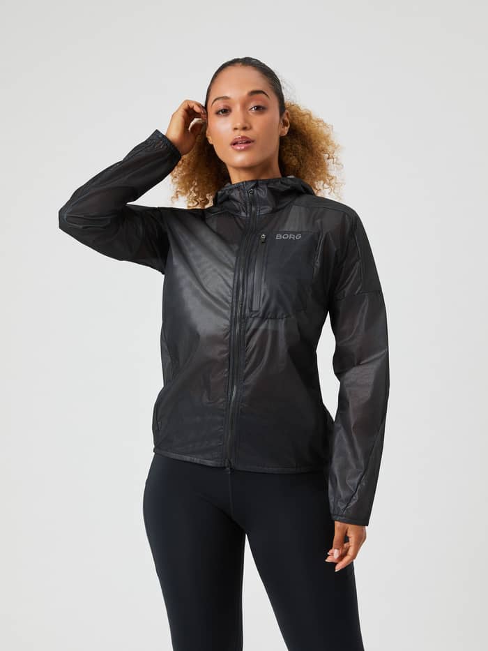 Front view of a woman wearing the Borg Running Jacket in Black Beauty (Black), a lightweight style with a performance fit. - Image 1