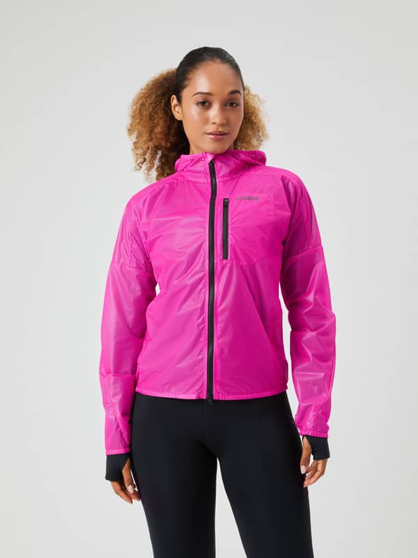 Front view of a woman wearing the Pink Glo (Pink) Borg Running Jacket in recycled polyamide for a stylish running fit.