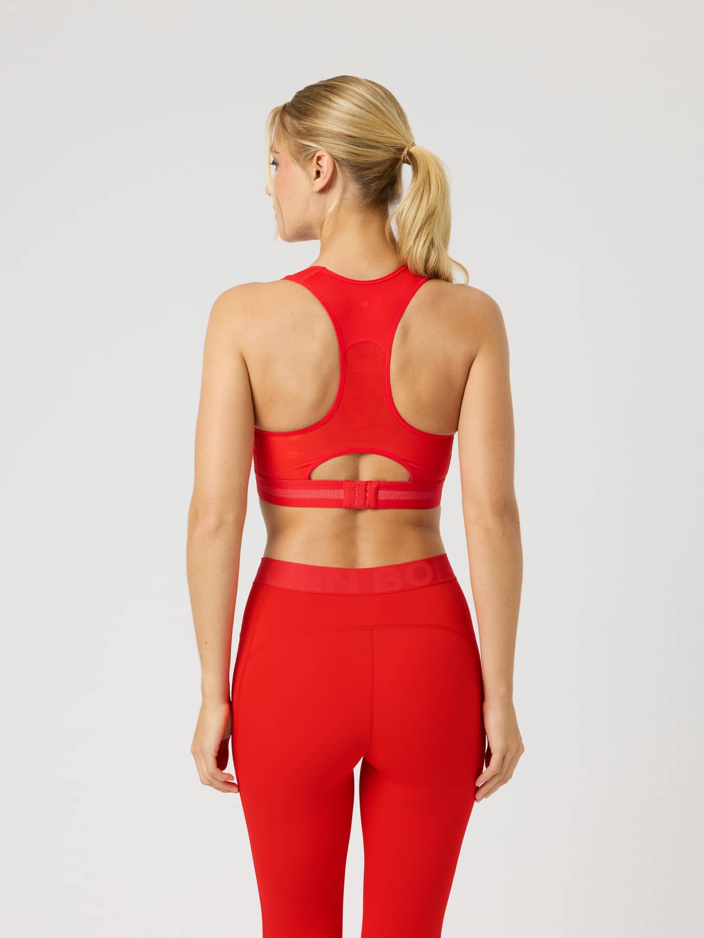 Back view of the Borg Performance High Support Bra in Flame Scarlet (Red) with racerback and power mesh for running. - Image 2
