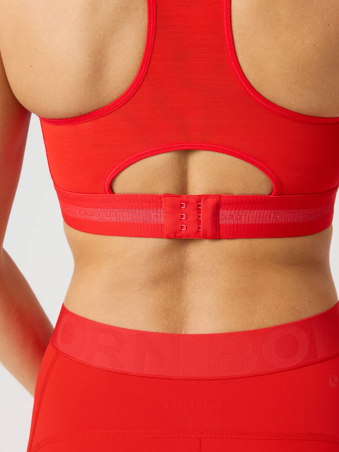 Back view of the Borg Performance High Support Bra in Flame Scarlet (Red) with red logo and hook-and-eye closure for running. - Image 4