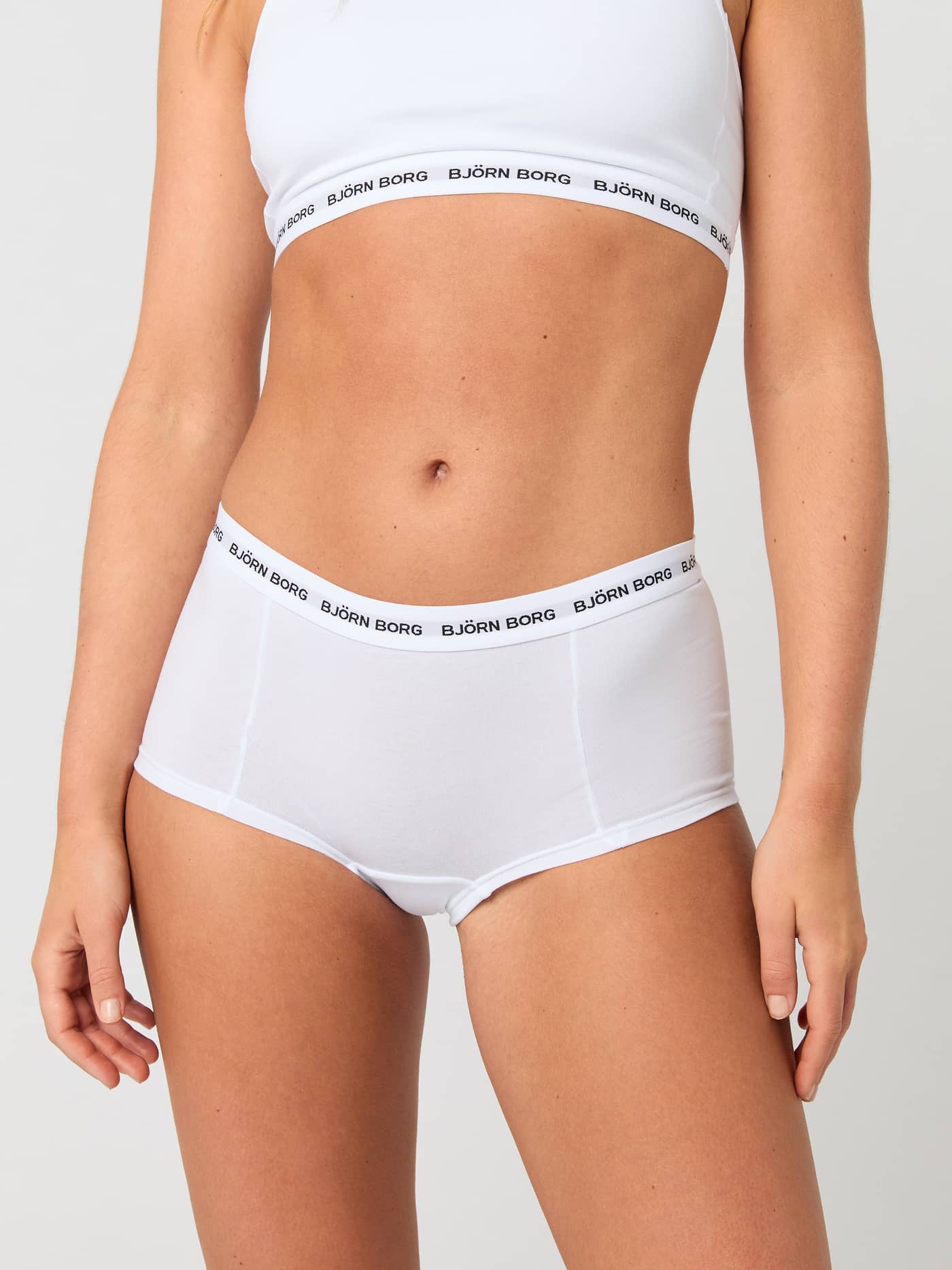 Front view of a model in the white Logo Boxer Shorts 3-pack, featuring a soft cotton stretch fit and black logo waistband. - Image 2