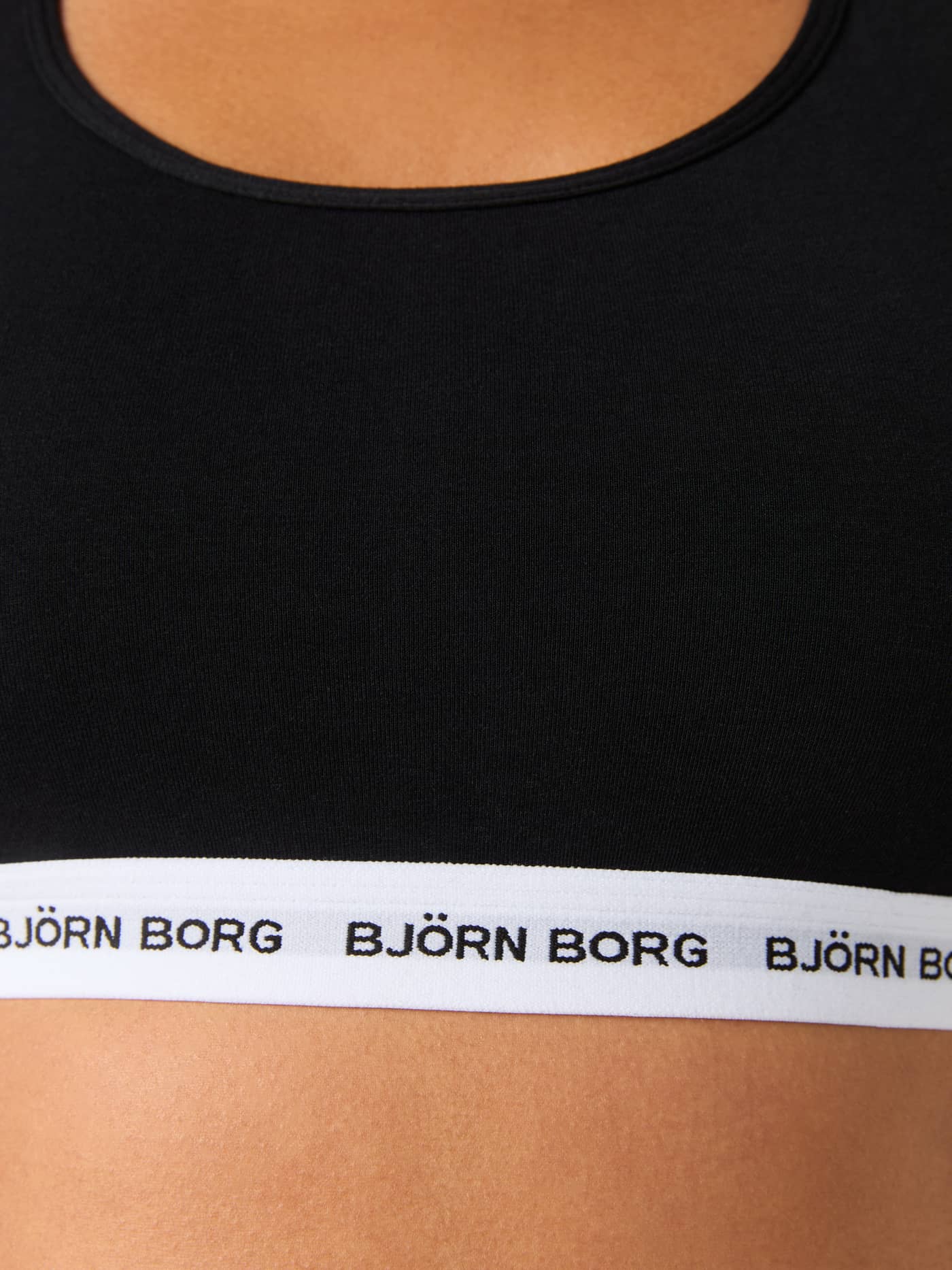 Close-up of the black Logo Soft Top, featuring soft cotton stretch for a comfortable fit and white branded elastic. - Image 6