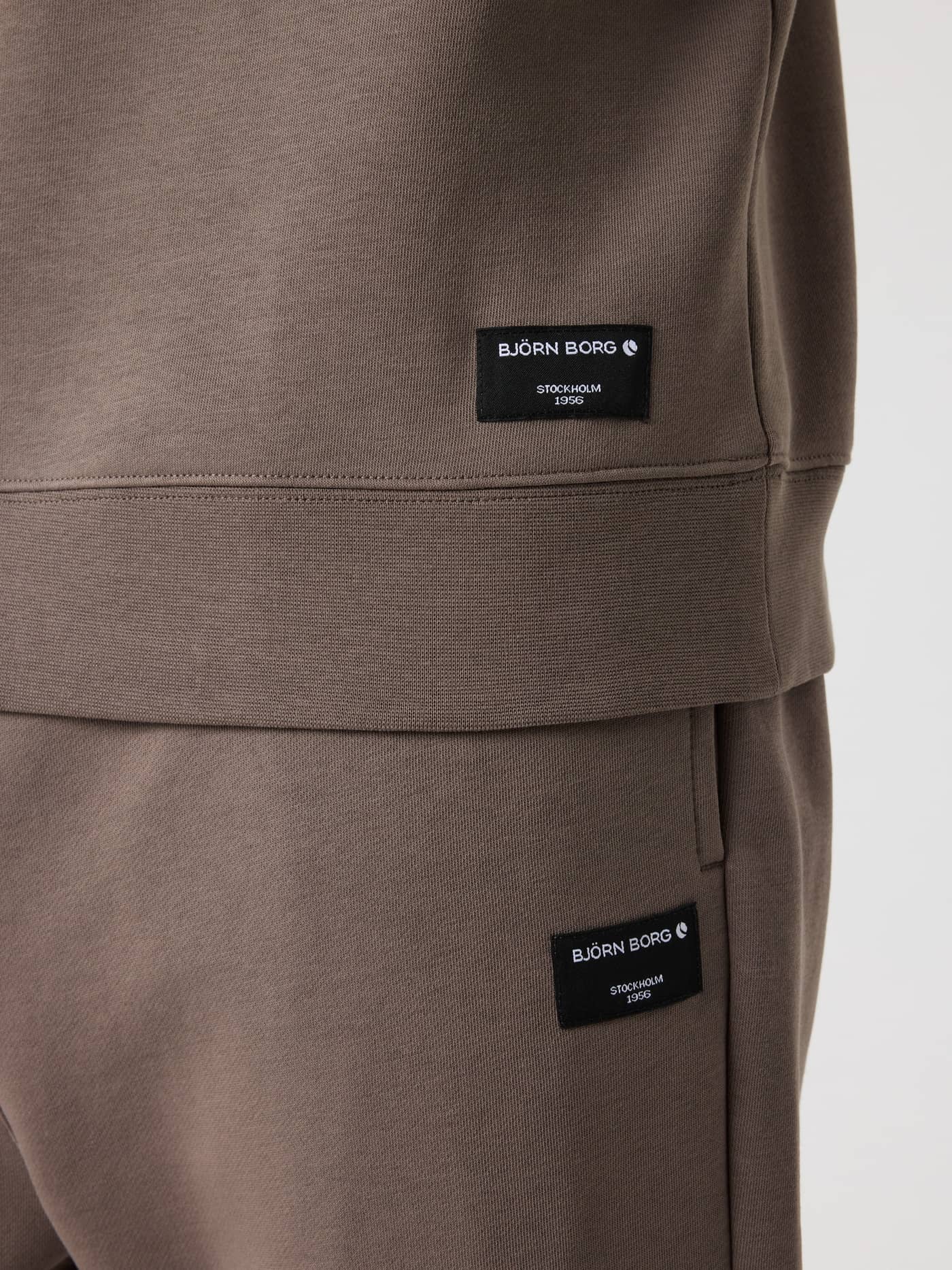 Close-up of the black logo labels on the Falcon (Brown) Björn Borg Centre Half Zip and matching pants. - Image 4
