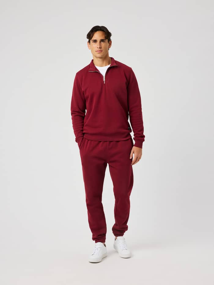 Front view of the Centre Half Zip in Cabernet (Red) worn by a model.