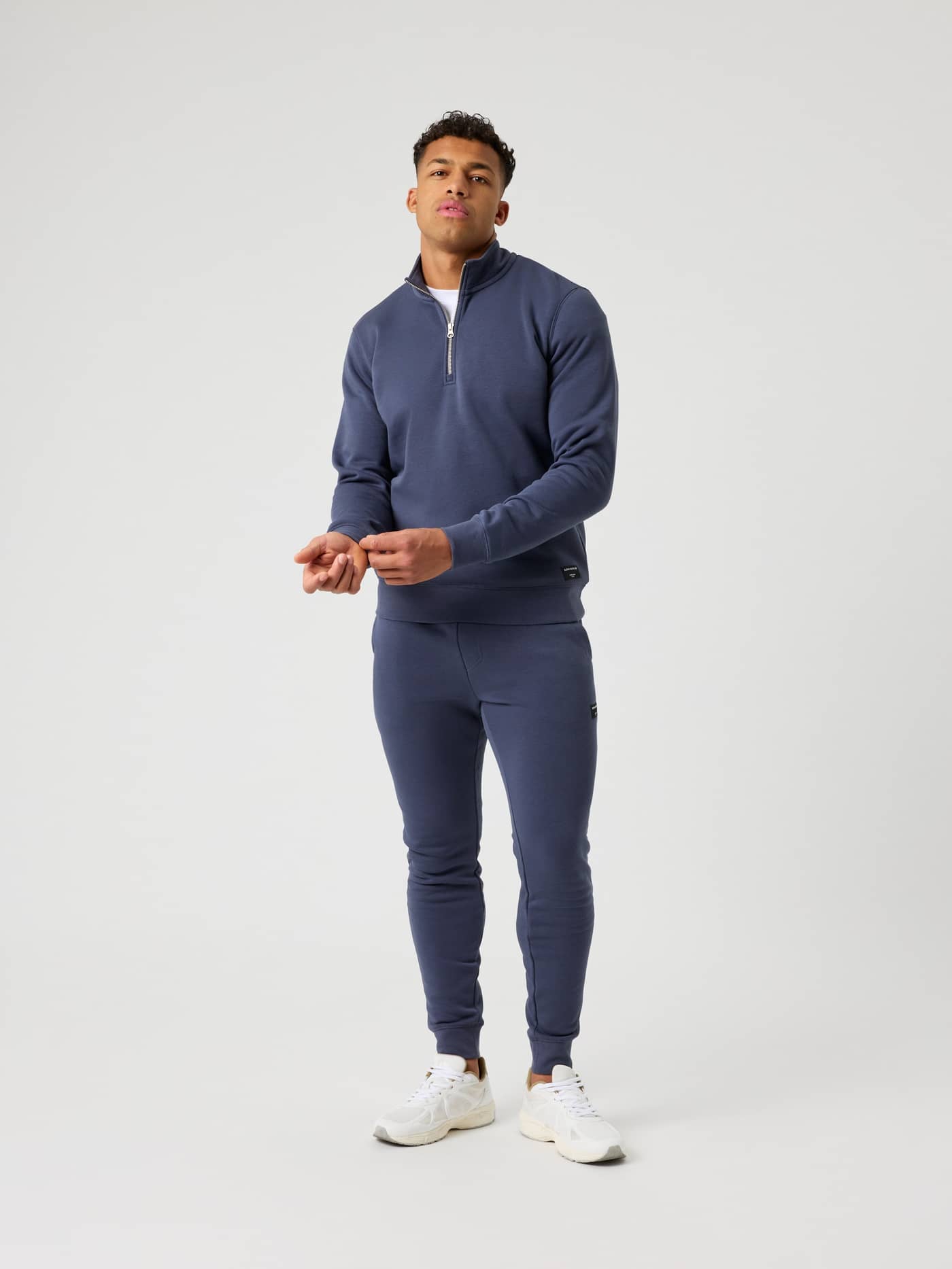 Full-body front view of a man wearing the regular fit Björn Borg Centre Half Zip in Odyssey Gray (Blue). - Image 3
