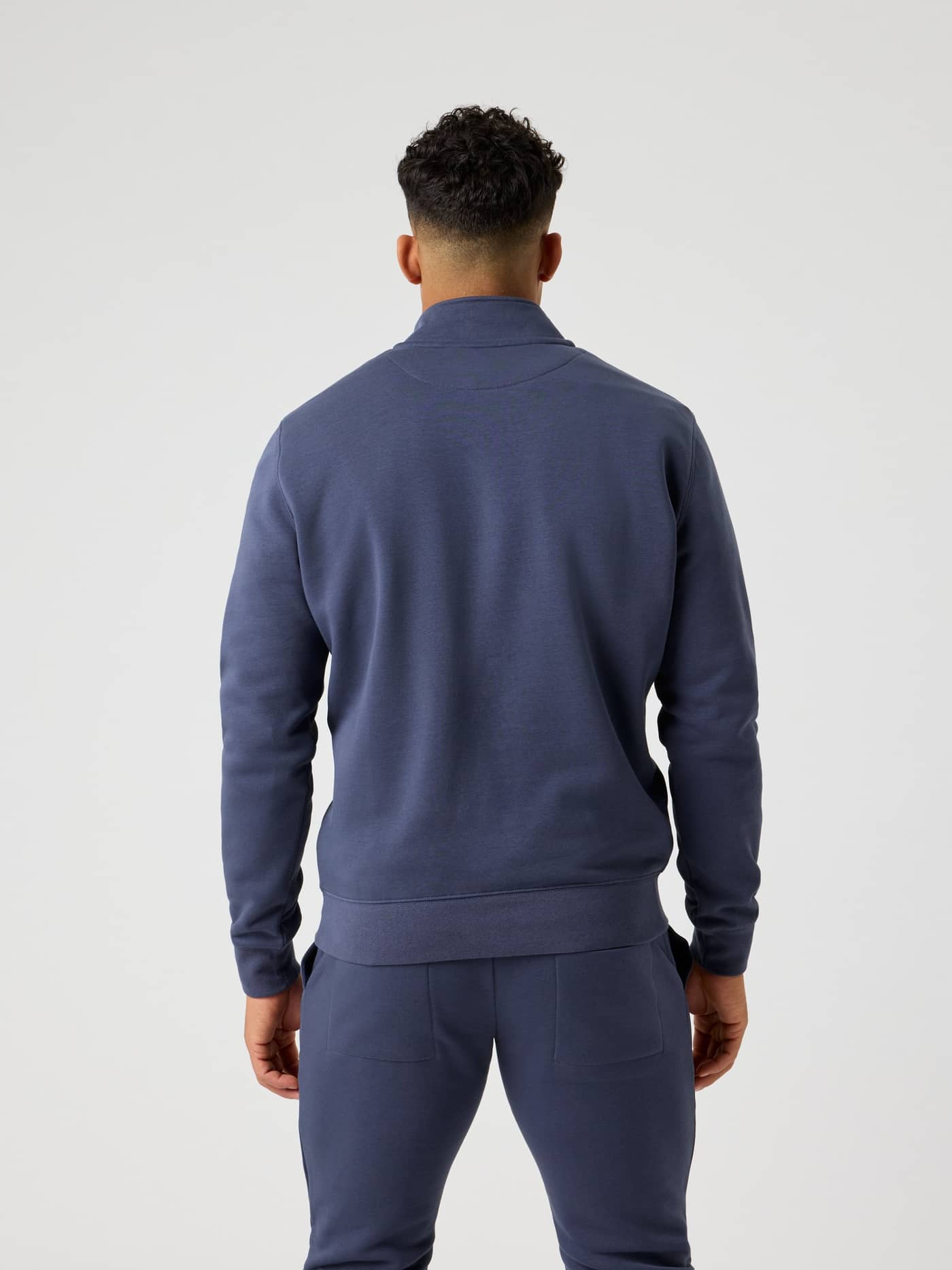Back view of a man wearing the Björn Borg Centre Half Zip in Odyssey Gray (Blue) with a stylish, regular cotton blend fit. - Image 4