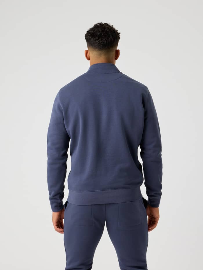Back view of a man wearing the Björn Borg Centre Half Zip in Odyssey Gray (Blue) with a stylish, regular cotton blend fit. - Image 4