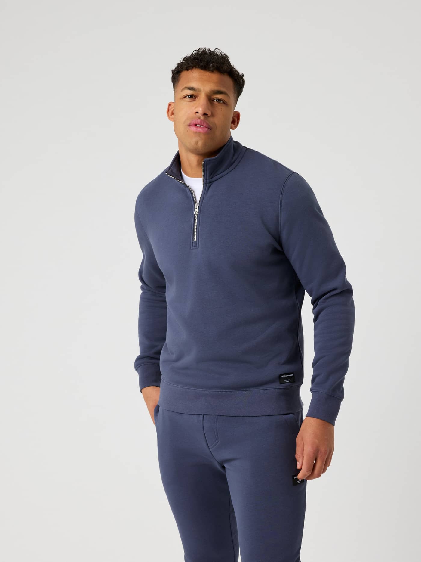 Front view of a man wearing the Björn Borg Centre Half Zip in Odyssey Gray (Blue), featuring a regular fit. - Image 2