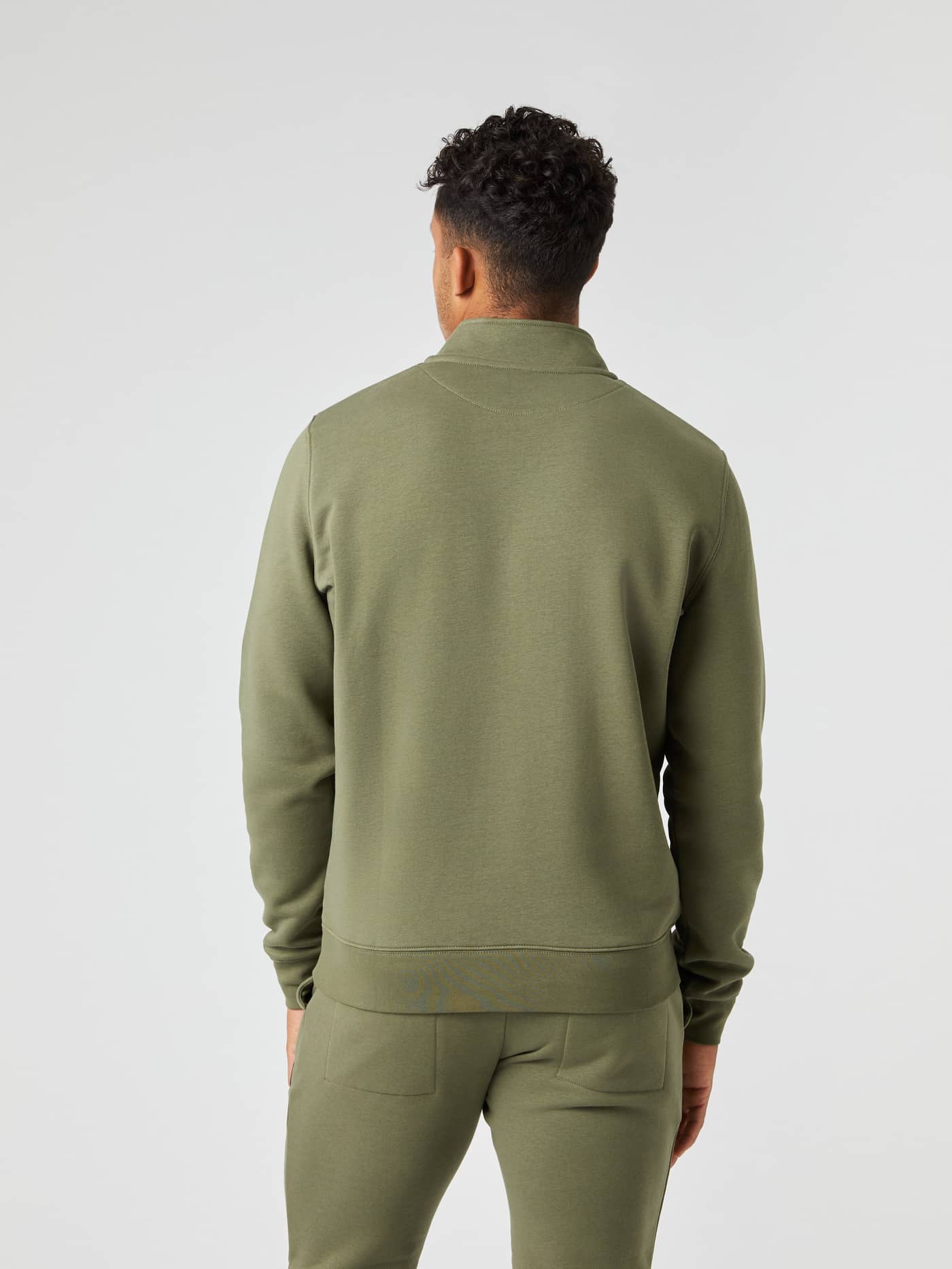 Back view of a model wearing the Björn Borg Centre Half Zip in Dusty Olive. - Image 2