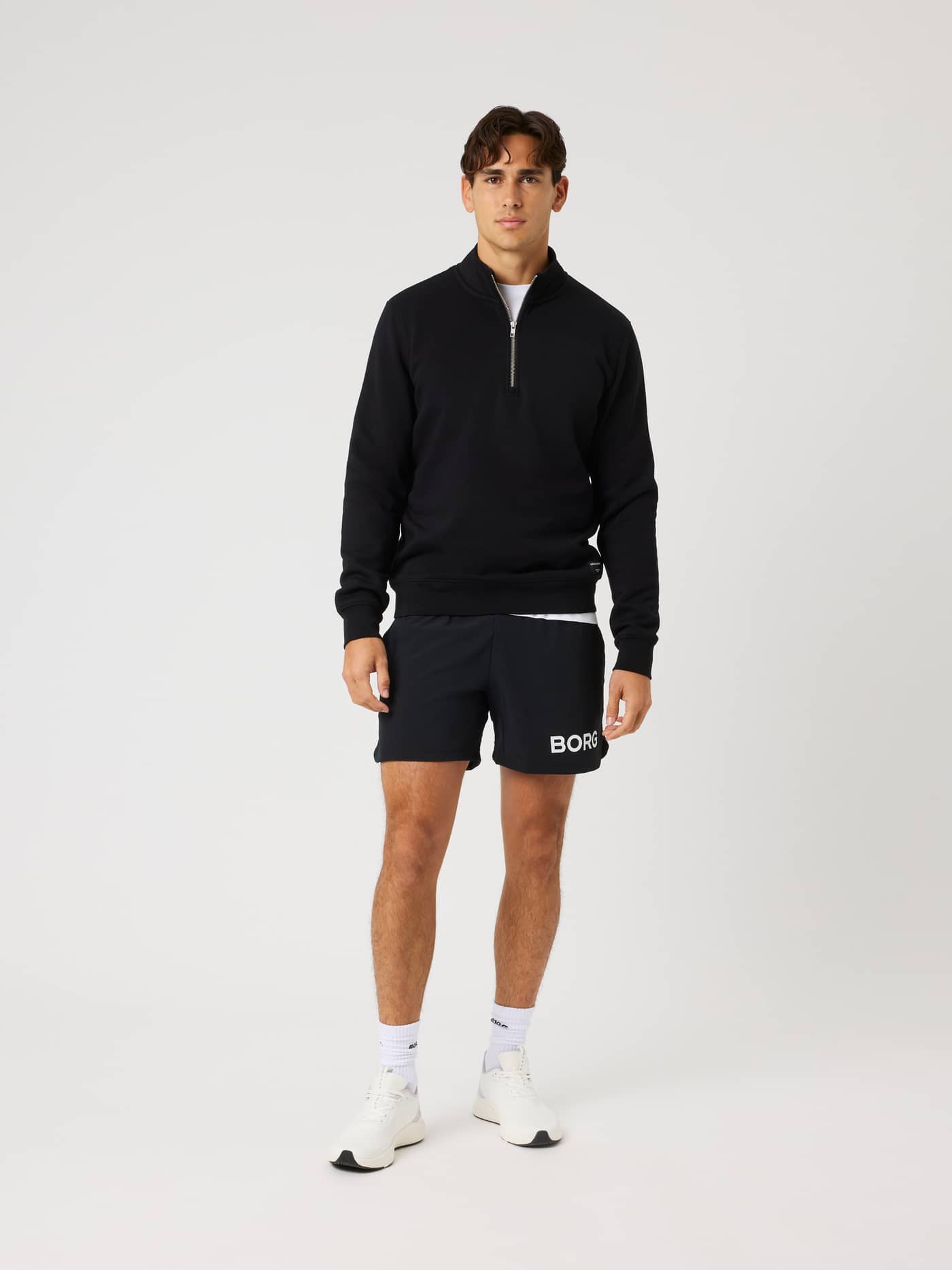 Full-body front view of a model wearing the Centre Half Zip in Black Beauty (Black) with a comfortable regular fit. - Image 3