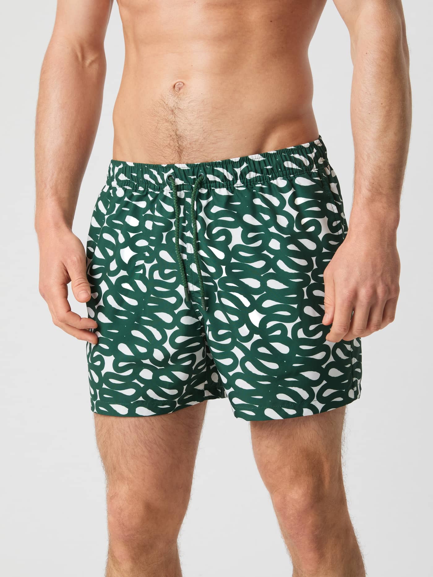 Model i Borg Print Swim Shorts i Serpent Big 1 (Grøn) med løs pasform, print og genanvendt polyester. - Image 2