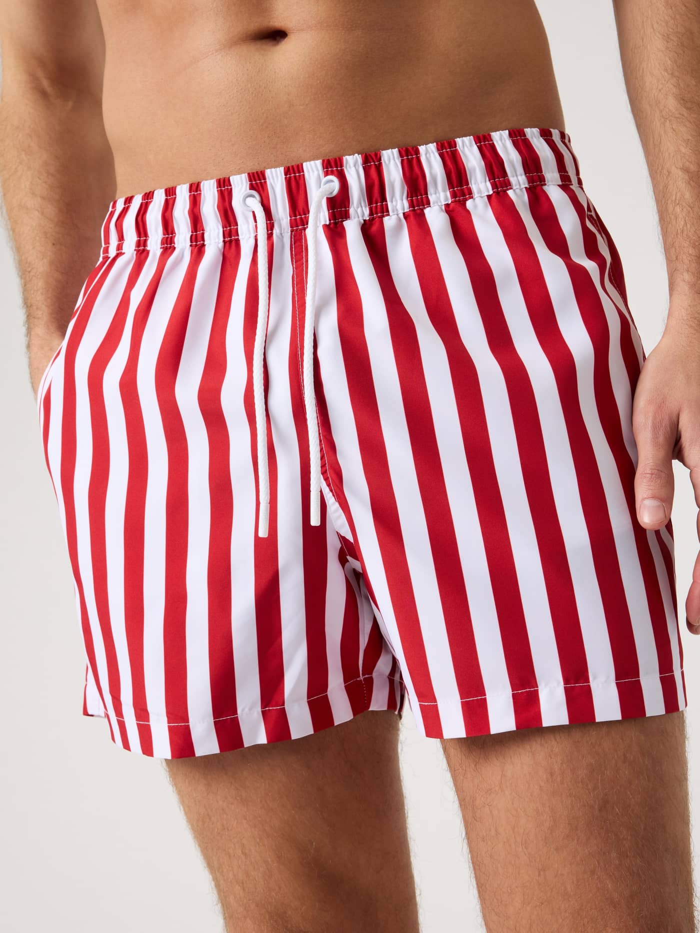 Front view of a man wearing the Borg Print Swim Shorts in Parasol 3 (Red, White) with bold stripes and a functional fit. - Image 5