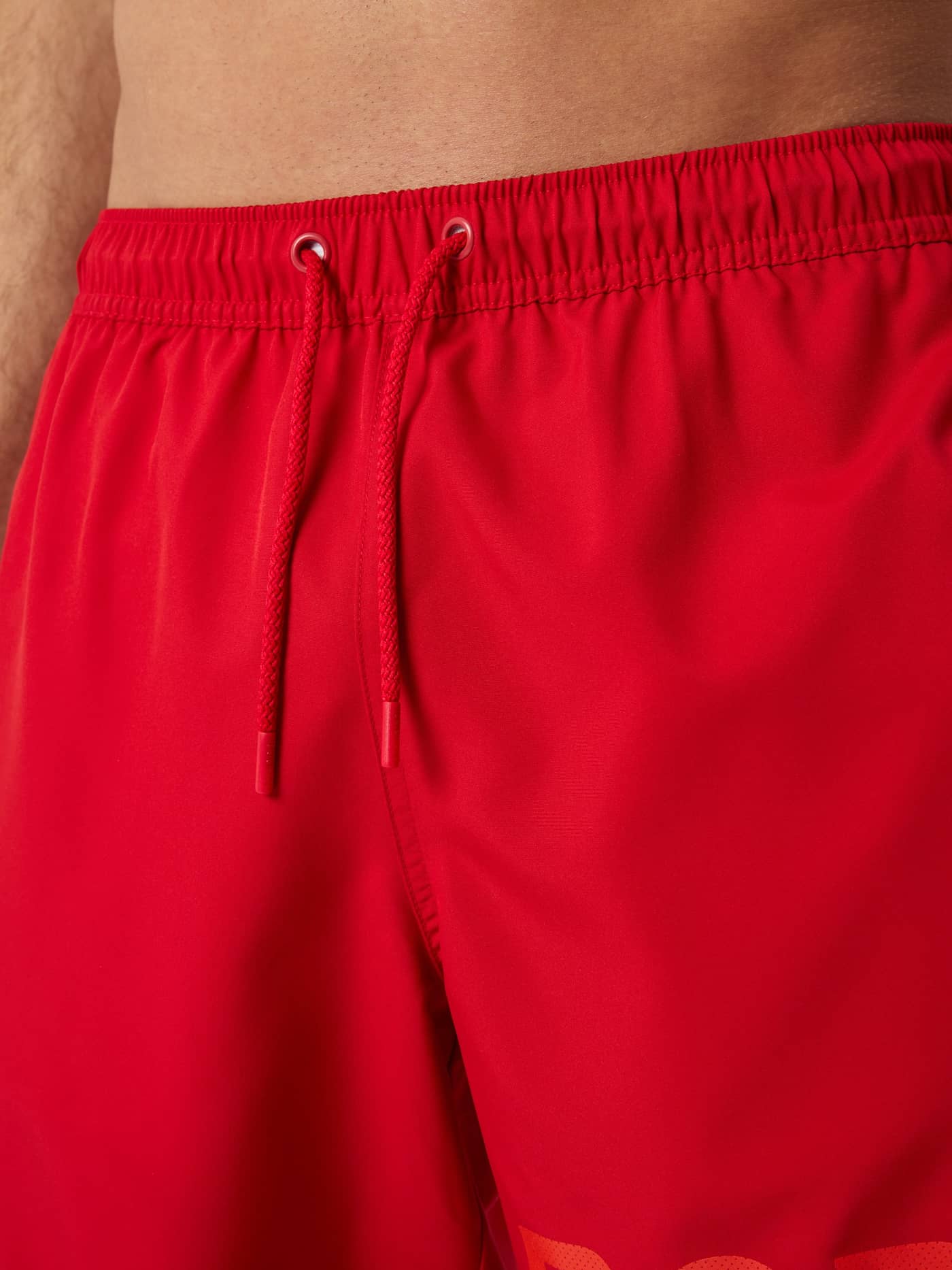 Detailed close-up of the Pompeian Red (Red) Borg Swim Shorts, featuring the functional drawstring and red logo print. - Image 5